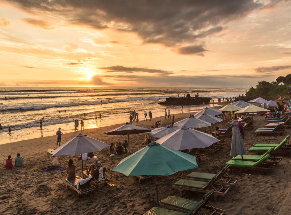 <p>People enjoy the sunset over Canggu beach, north of Kuta and Seminyak, in Bali</p>