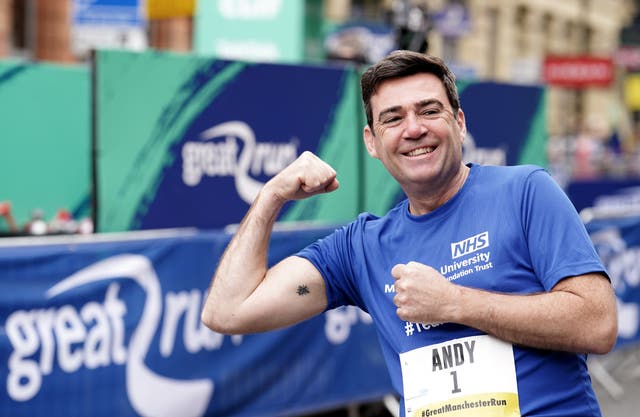 Andy Burnham shows his Manchester worker bee tattoo ahead of the Great Manchester Run (Martin Rickett/PA)