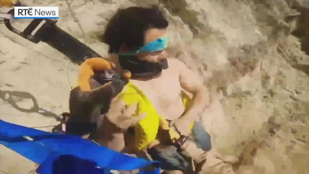 Shocking moment man trapped on 500ft cliff is rescued by helicopter