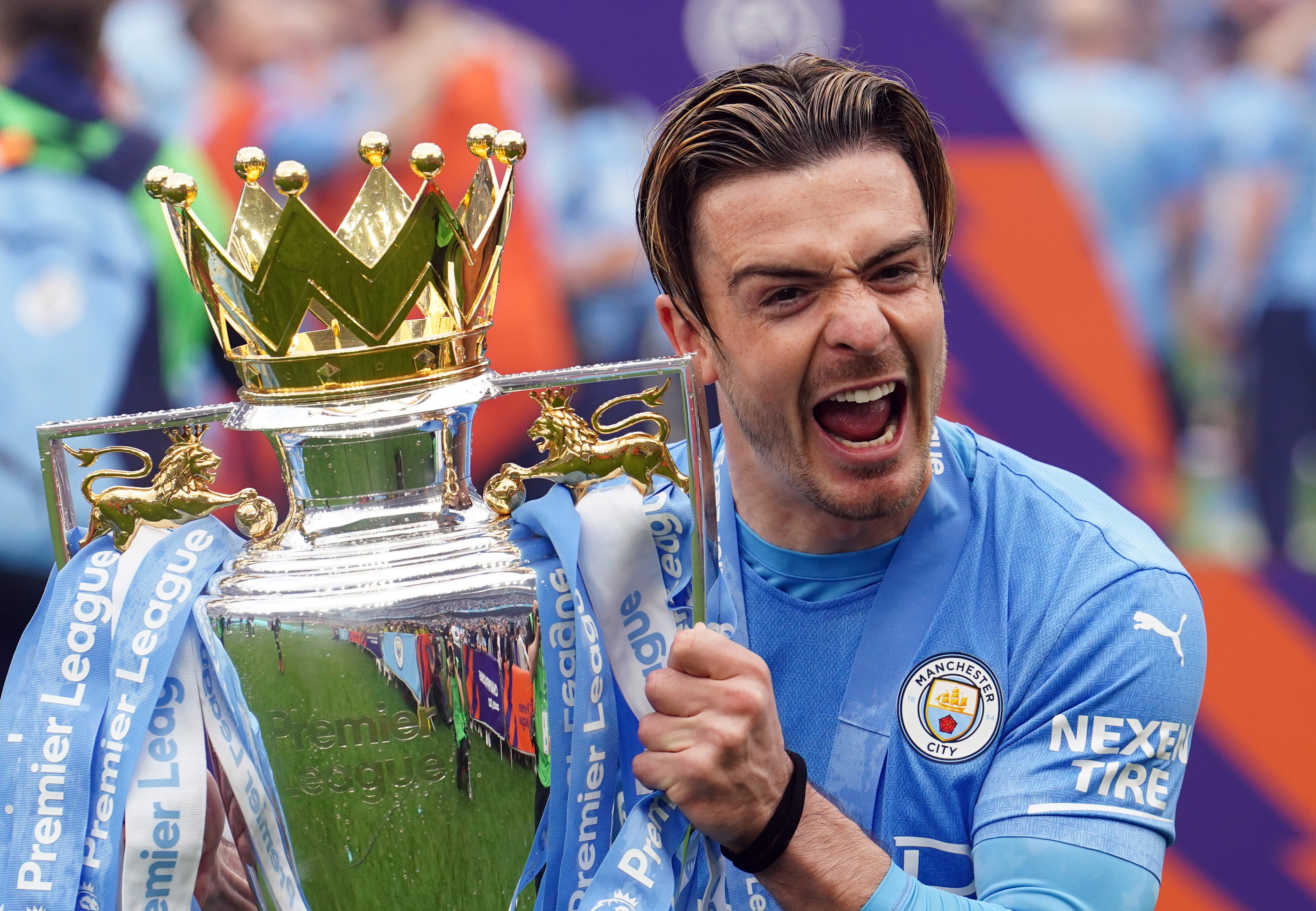 Jack Grealish lifts the trophy, his first since joining City (Martin Rickett/PA)