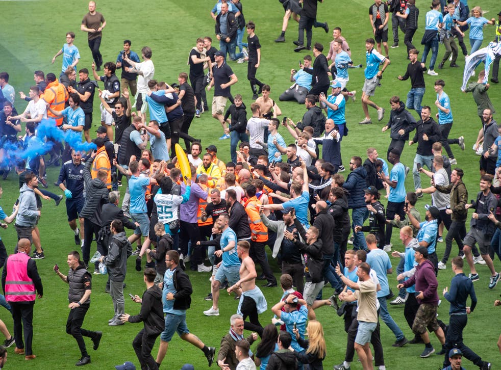 <p>Thousands of fans rushed the pitch after City won Premier League title on Sunday </p>