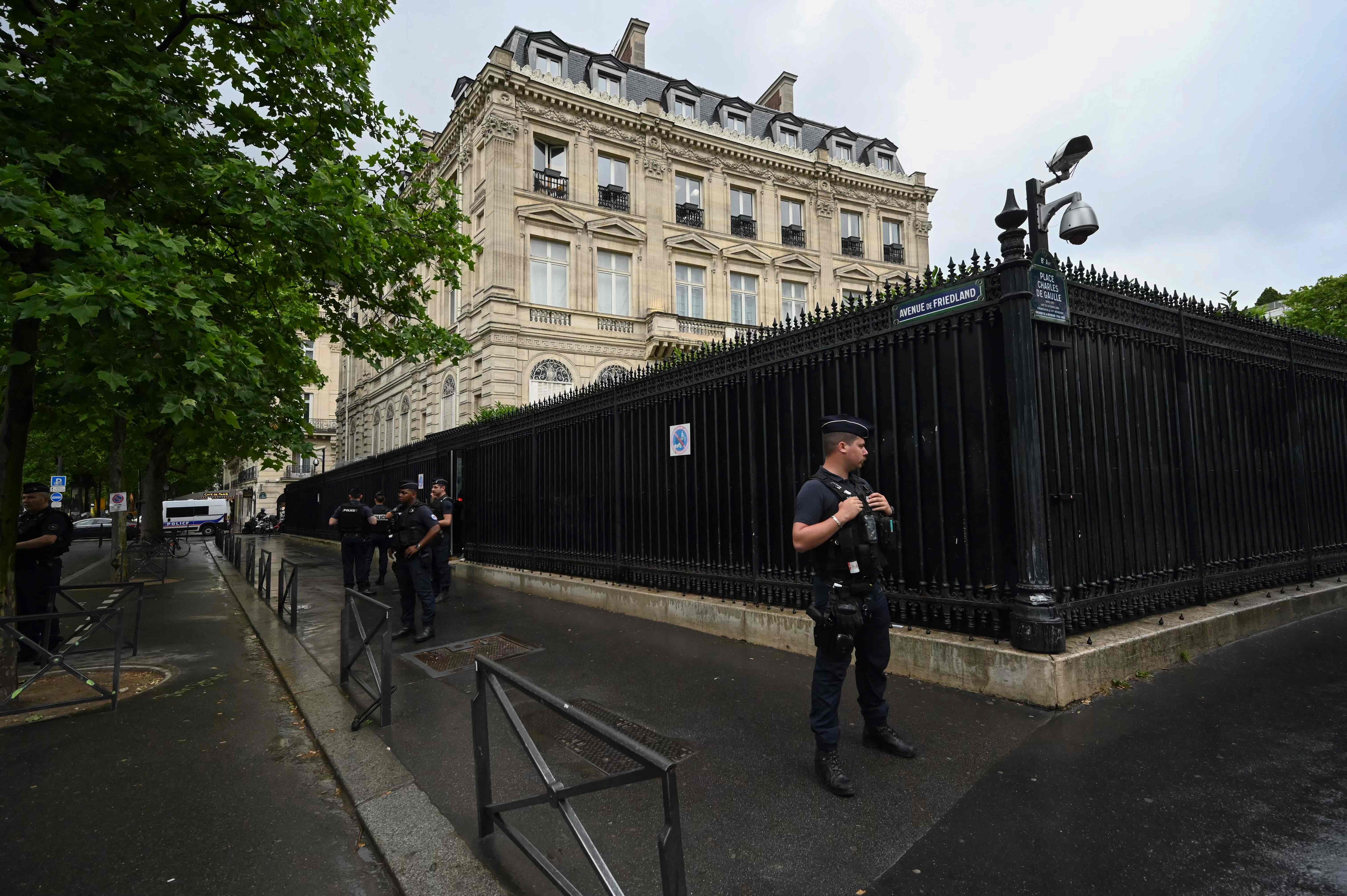 French policemen take position outside the Qatar Embassy in Paris on May 23. 2022, following an incident during which a security guard died