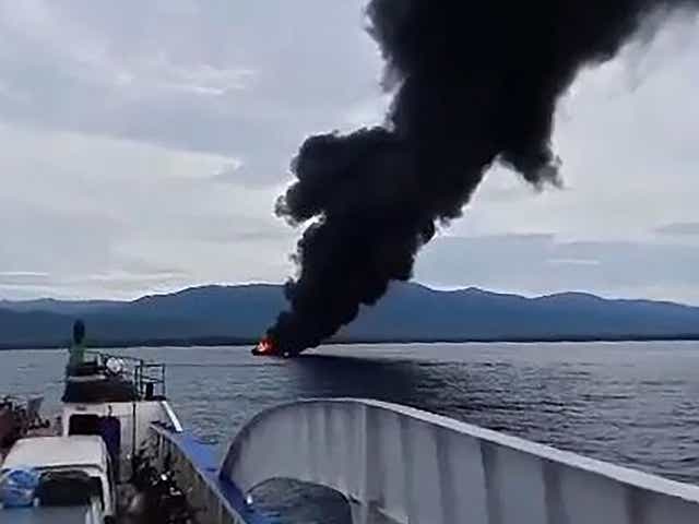 <p>A still from the video shows black smoke rising from a burning ferry as seen from another ferry off Real town, Quezon province</p>