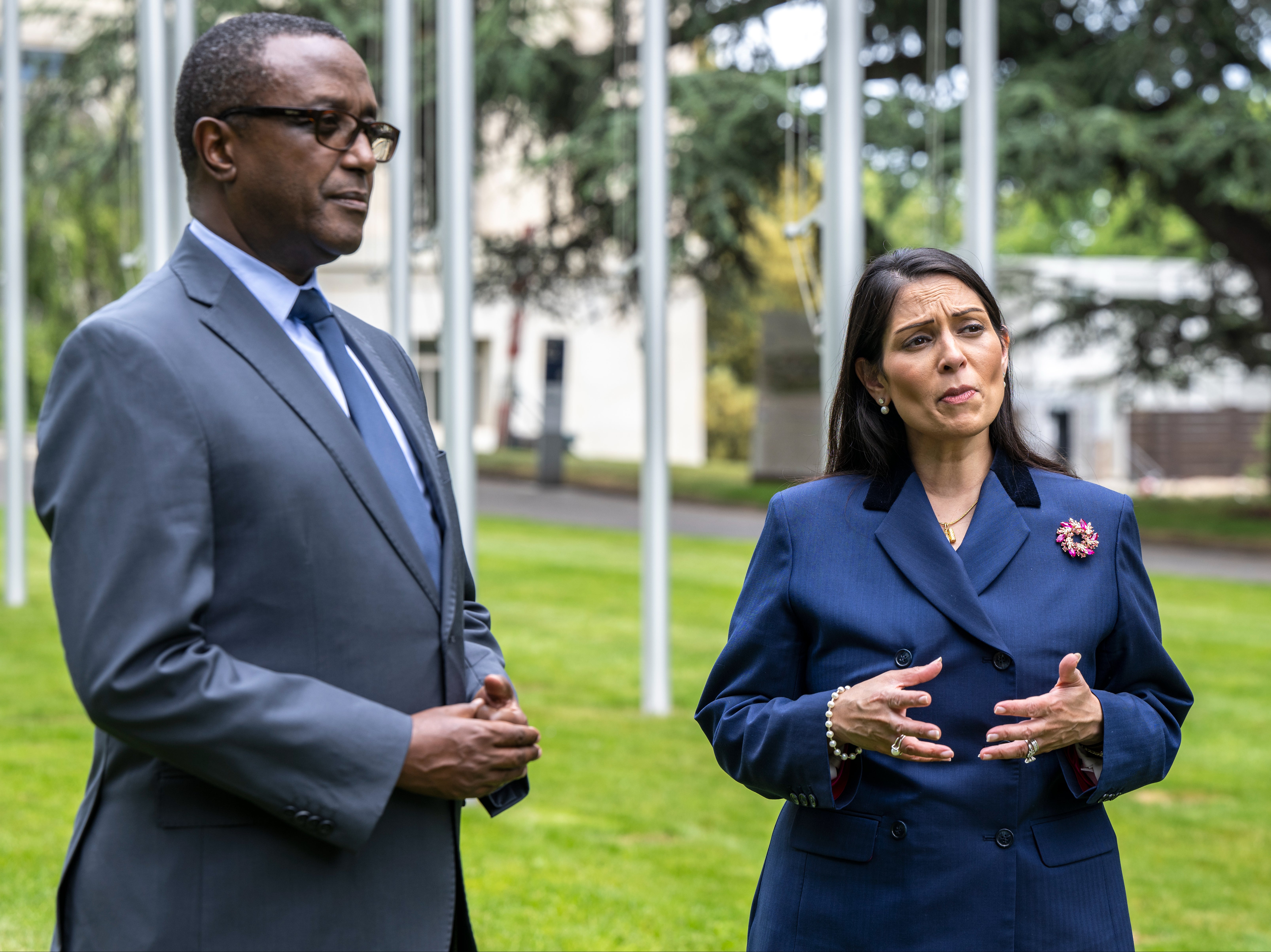 Rwandan foreign minister Vincent Biruta and home secretary Priti Patel, right, during a visit to the UN headquarters in Geneva on 19 May 2022