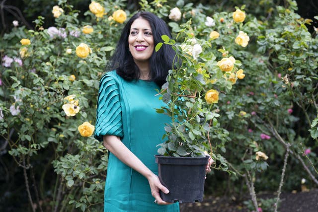 Zehra Zaidi, founder of the We Too Built Britain campaign, holds a John Ystumllyn rose in the gardens of Buckingham Palace (Kirsty O’Connor/PA)