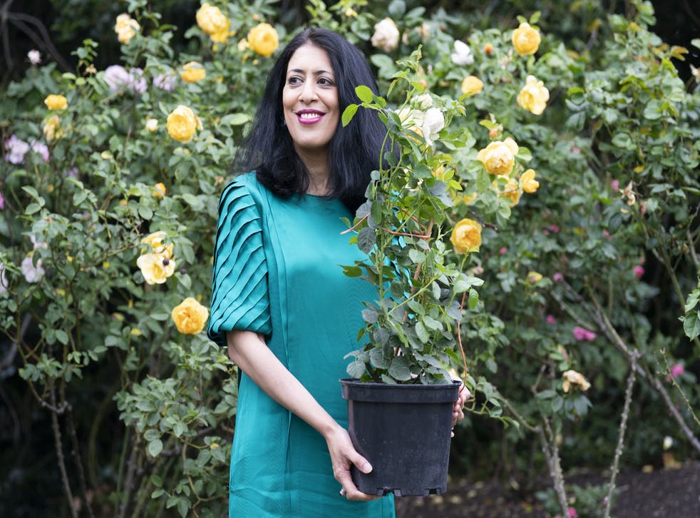 Zehra Zaidi, founder of the We Too Built Britain campaign, holds a John Ystumllyn rose in the gardens of Buckingham Palace (Kirsty O’Connor/PA)