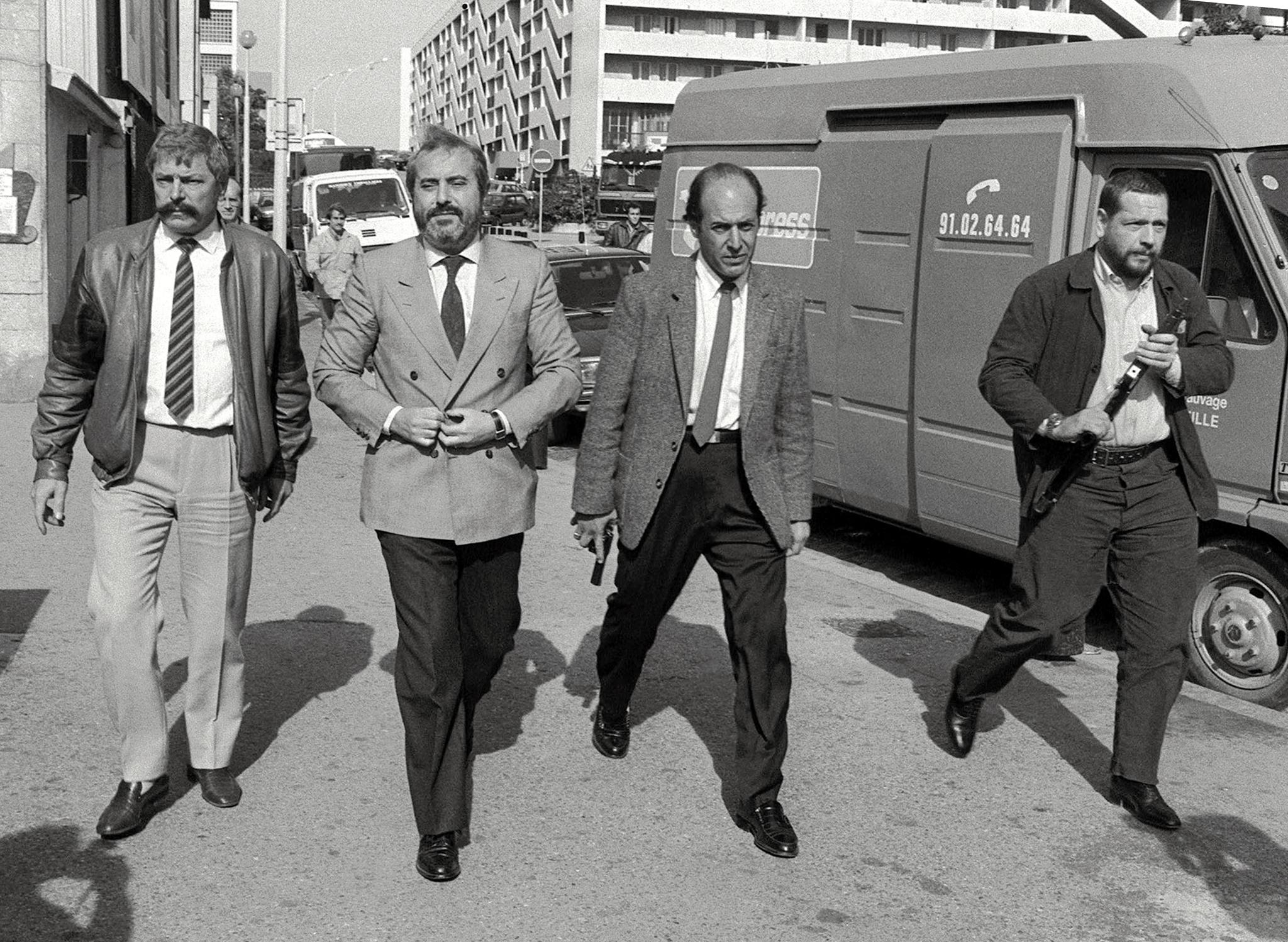 In a photo taken in October 1986, Italian Judge Giovanni Falcone (2ndL), is surrounded by his bodyguards in Marseille to meet his French counterparts to investigate in the Mafia ‘Pizza Connection’ criminal plot