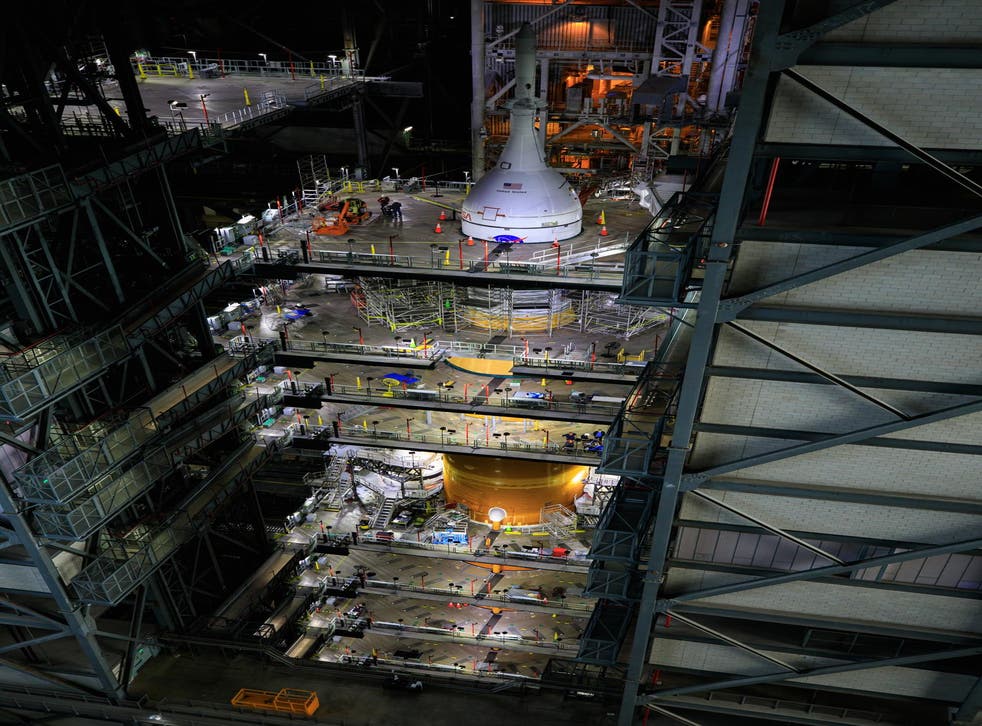 <p>Ground teams work on Nasa’s Space Launch System Moon rocket and Orion spacecraft inside the Vehicle Assembly Building at Kennedy Space Center in Florida</p>