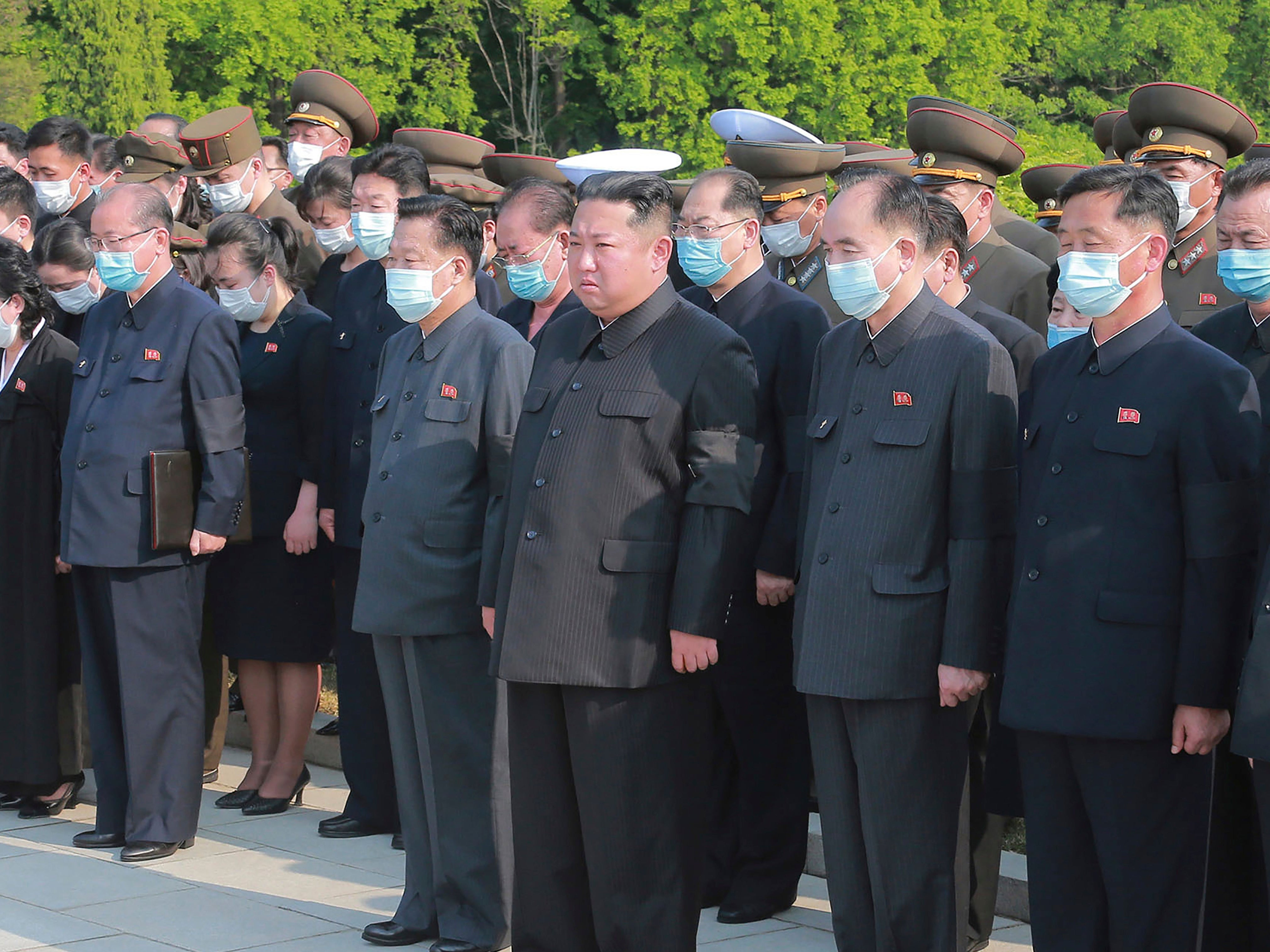 North Korean leader Kim Jong Un (centre) is seen without a mask at a ceremony in Pyongyang on 22 May