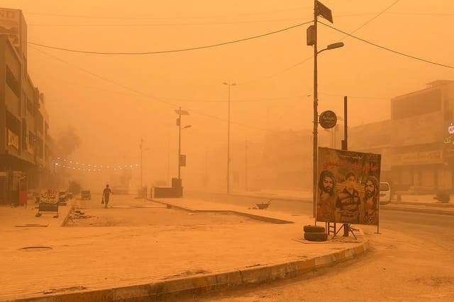 <p>A man walks through Baghdad, Iraq, during a sandstorm on 5 May, 2022</p>