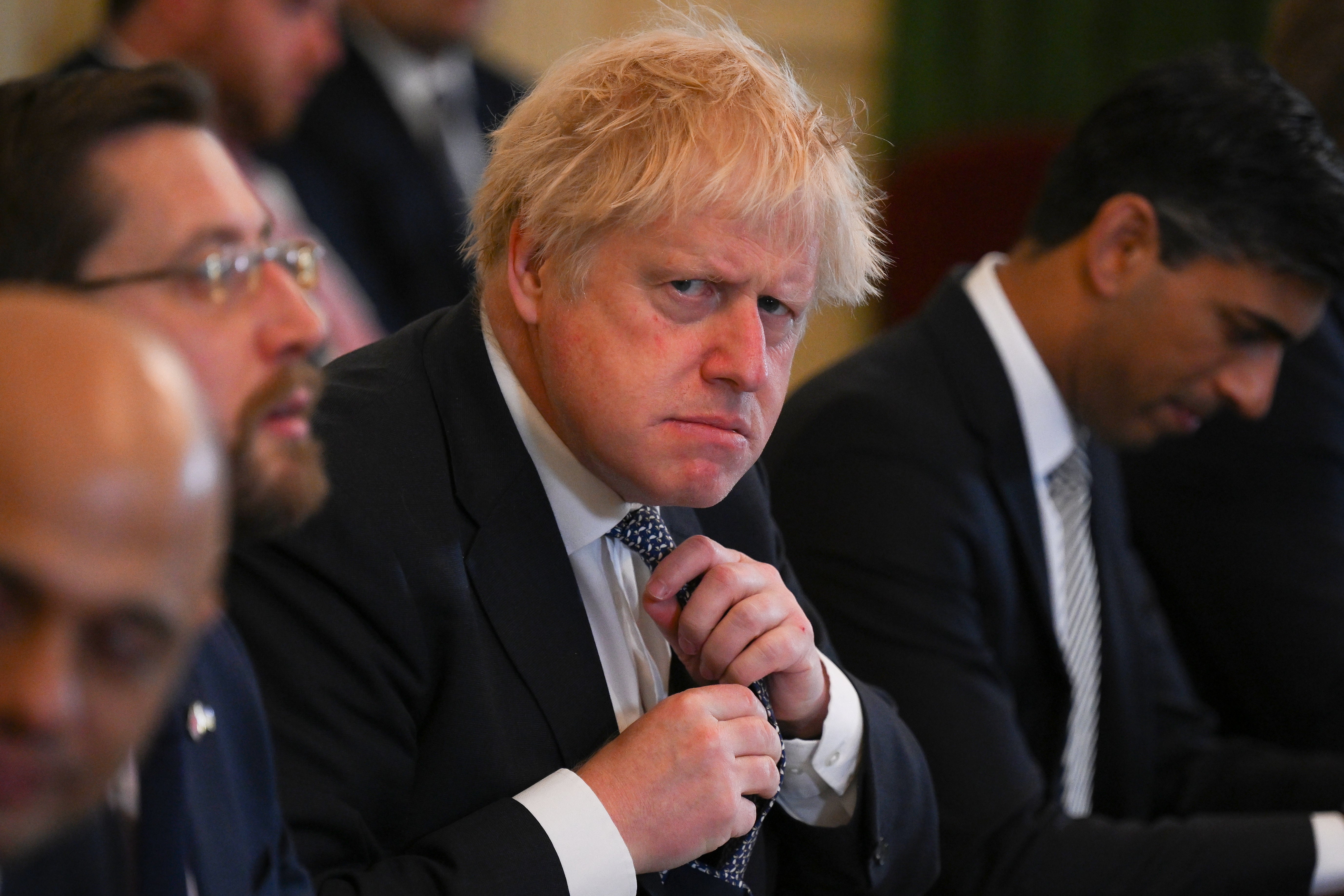 Prime Minister Boris Johnson adjusts his tie at the start of a Cabinet meeting on Tuesday (Daniel Leal/PA)