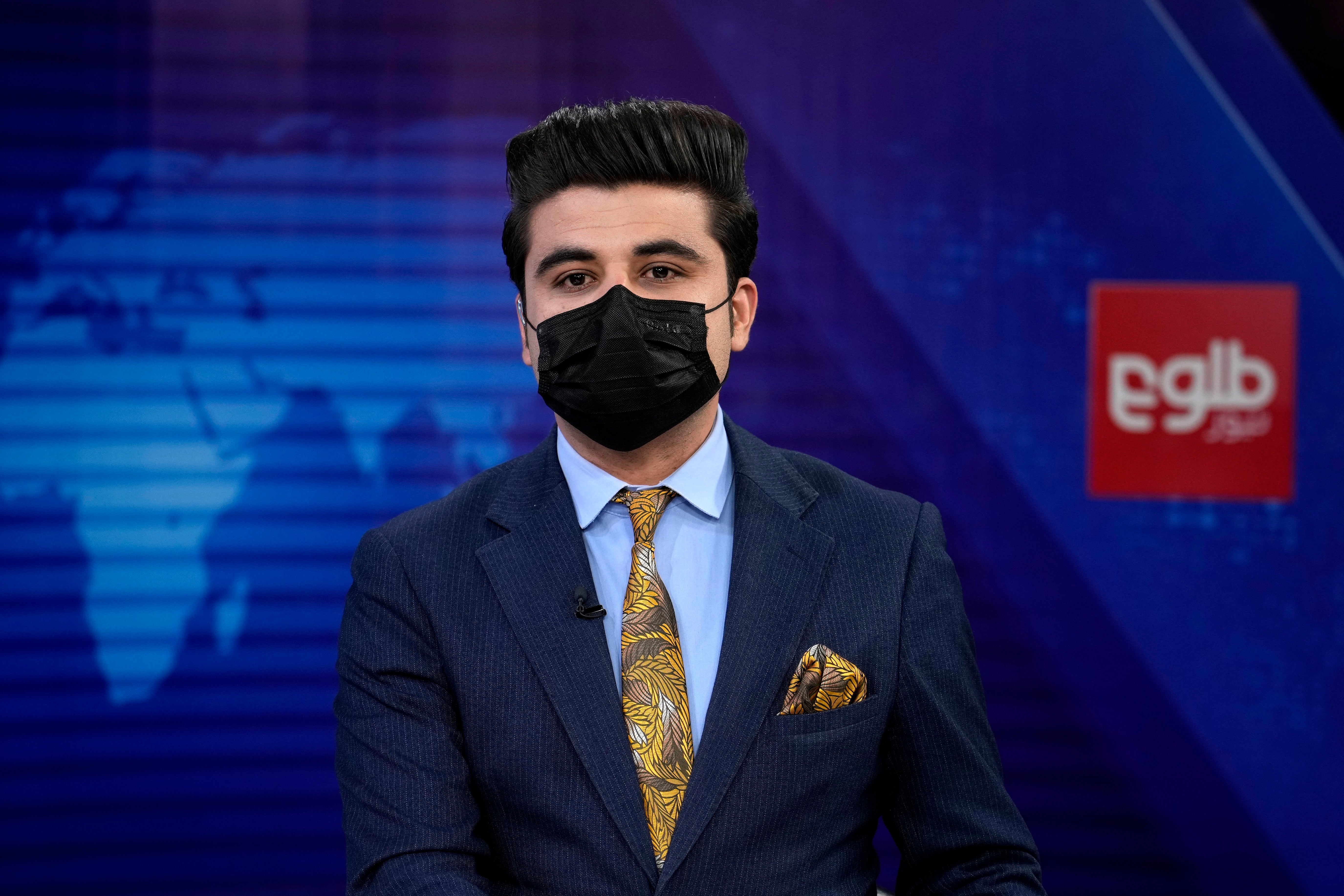 TOLOnews TV anchor Nesar Nabil wears a face mask to protest the Taliban’s new order that female presenters cover their faces on air