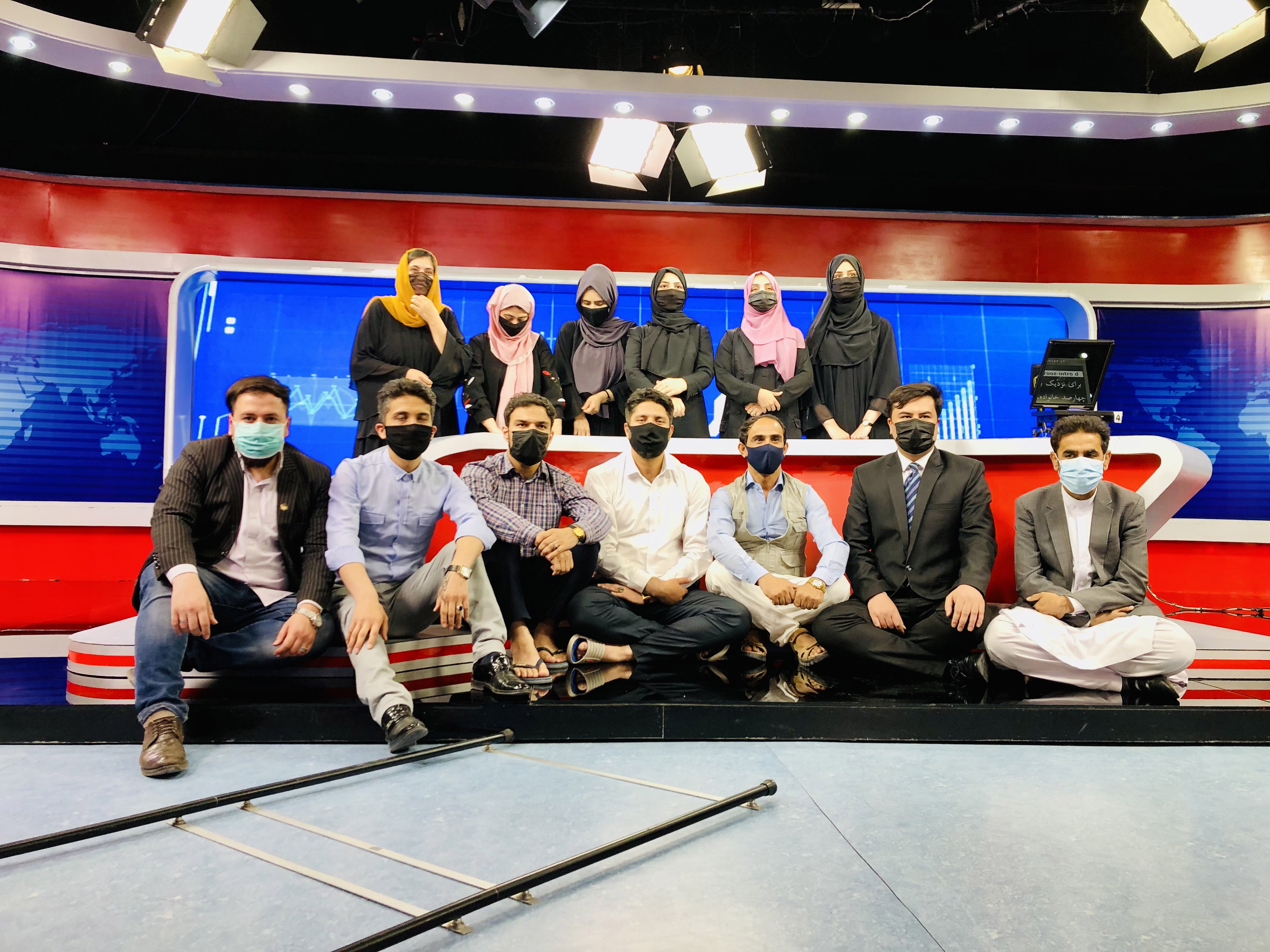 Afghan male staff at Tolo TV wears face masks to show solidarity with their female colleagues