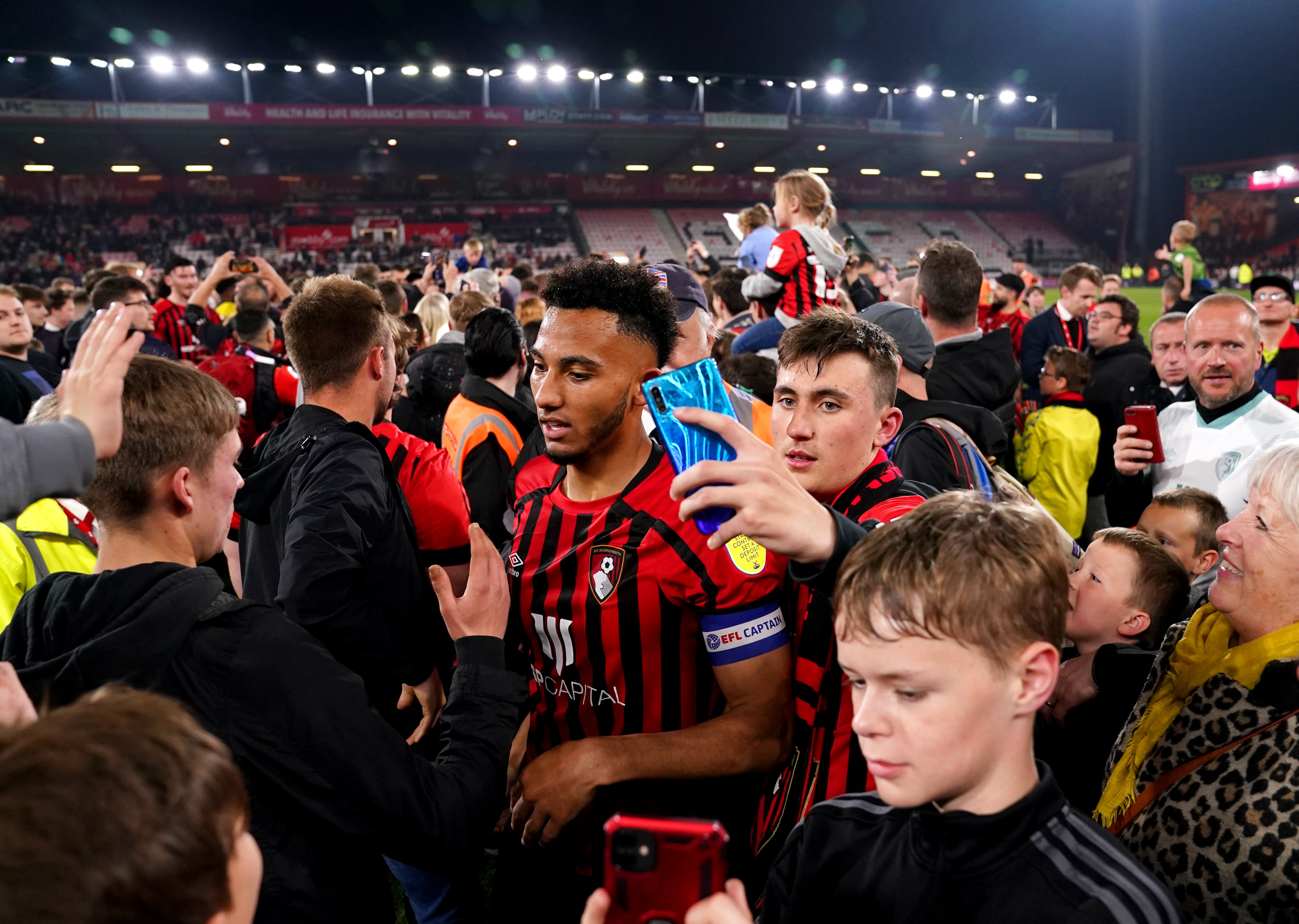 Fans spilled on to the pitch at full-time (John Walton/PA)