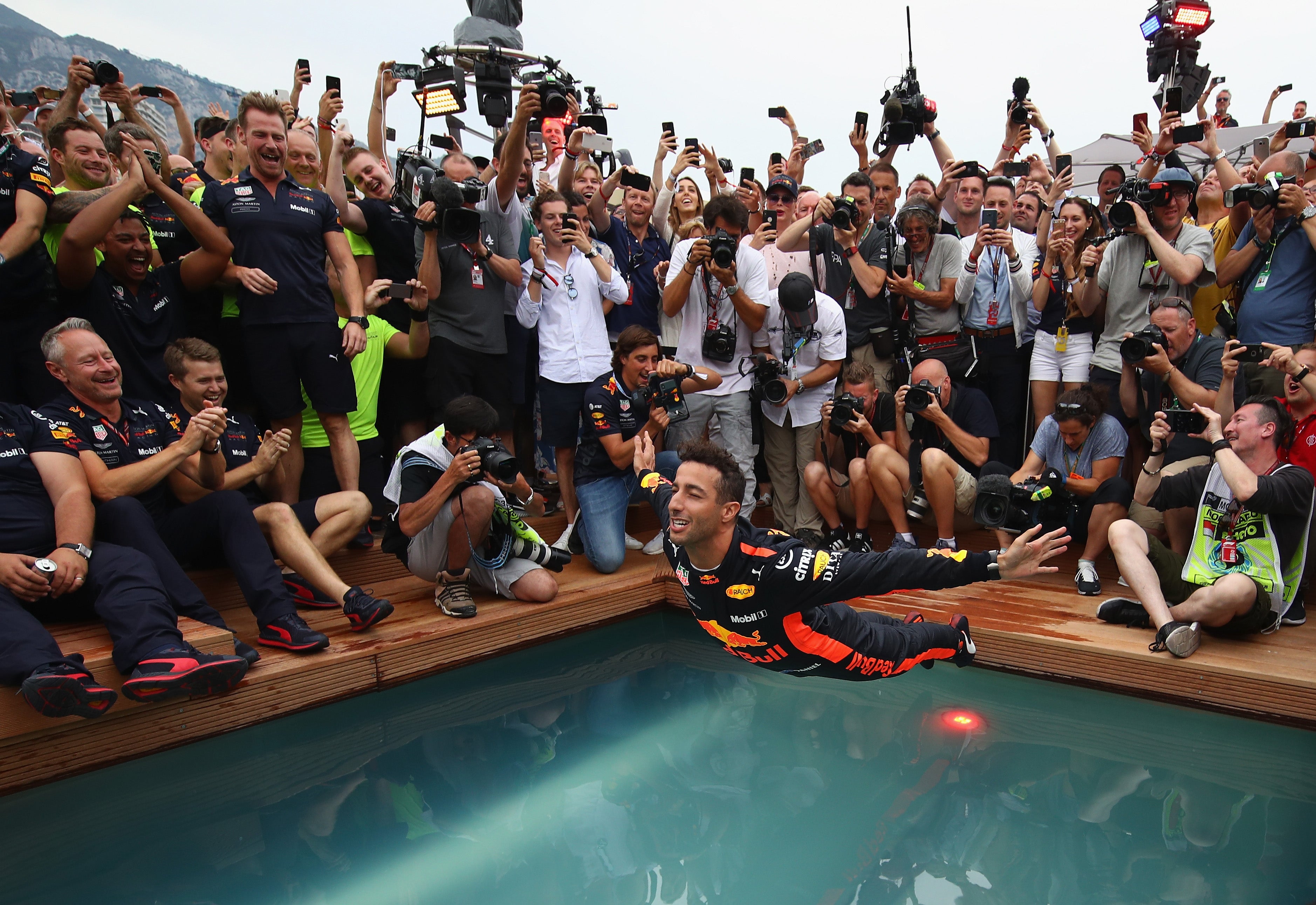 Daniel Ricciardo swan dives into the Red Bull swimming pool after victory in 2018