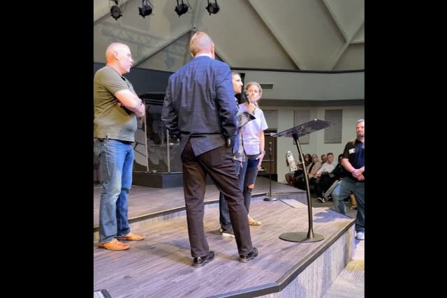 <p>Rev John Lowe II is confronted by a congregant at the New Life Christian Church & World Outreach in Warsaw, Indiana on Sunday</p>