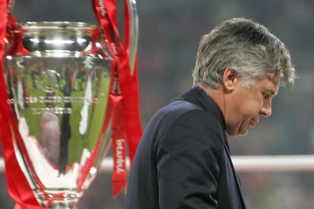 <p>Carlo Ancelotti walks past the Champions League trophy in 2005</p>