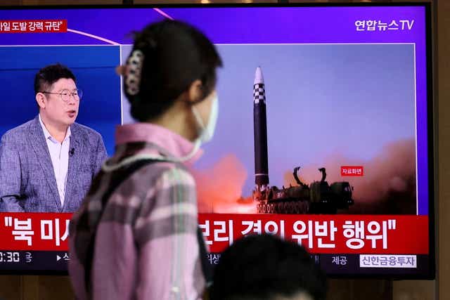 <p>A woman watches a news report on North Korea's launch of three missiles in Seoul on 25 May</p>