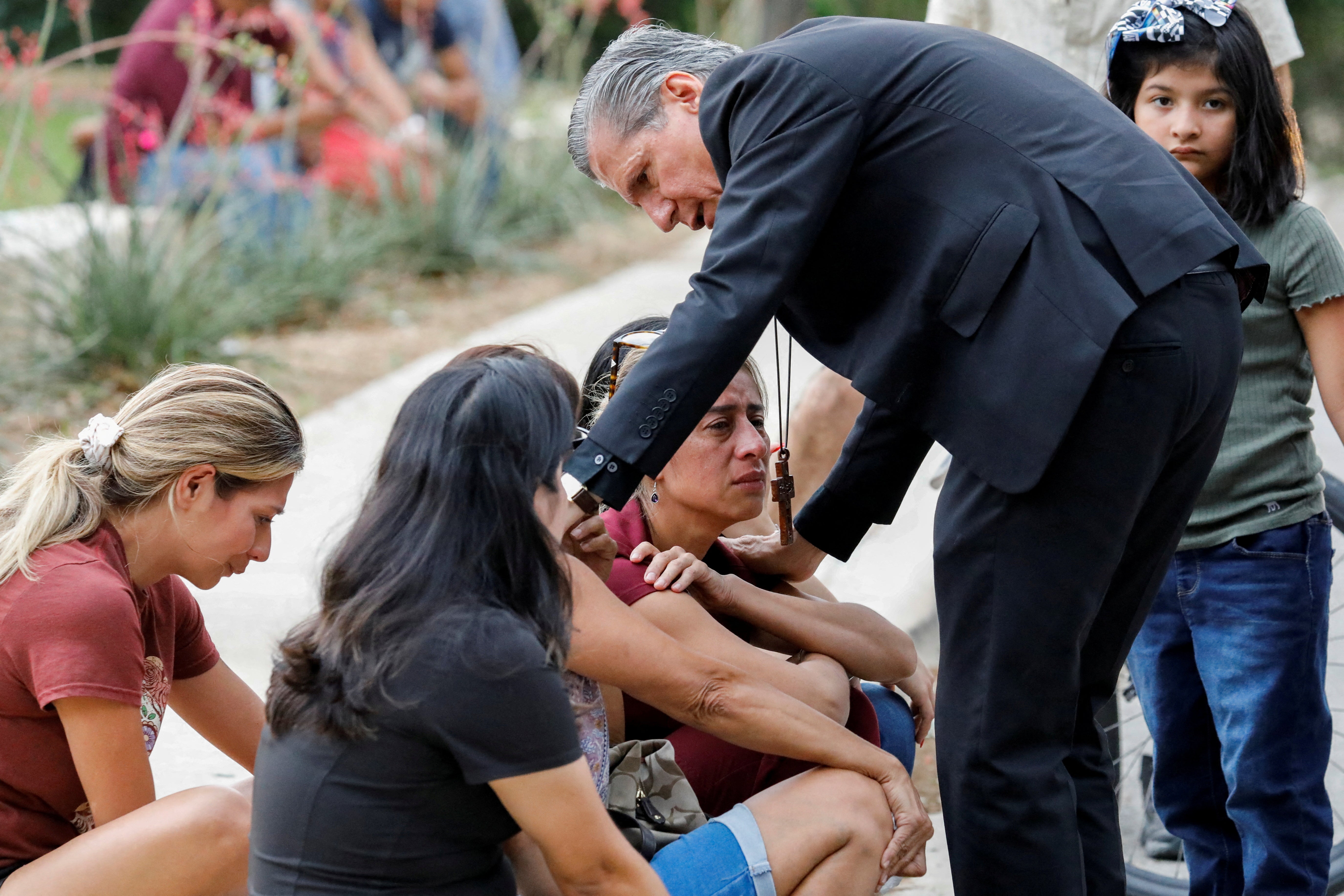Gustavo Garcia-Siller, Archbishop of the Archdiocese of San Antonio, comforts people as they react outside the Ssgt Willie de Leon Civic Center, where students had been transported from Robb Elementary School after a shooting, in Uvalde, Texas, US on 24 May 2022