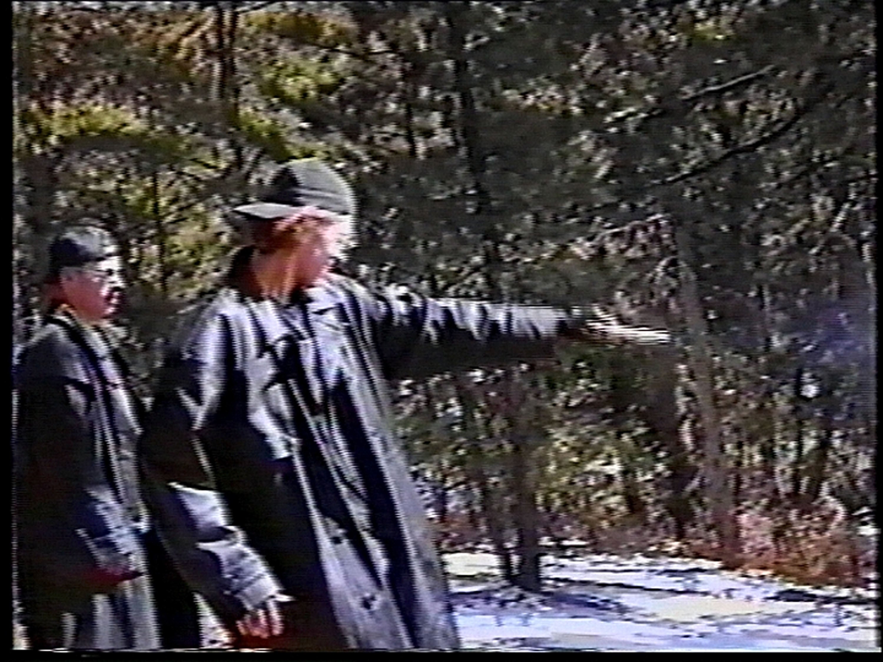 Eric Harris (L) watches as Dylan Klebold practices shooting a gun at a makeshift shooting range March 6, 1999 in Douglas County
