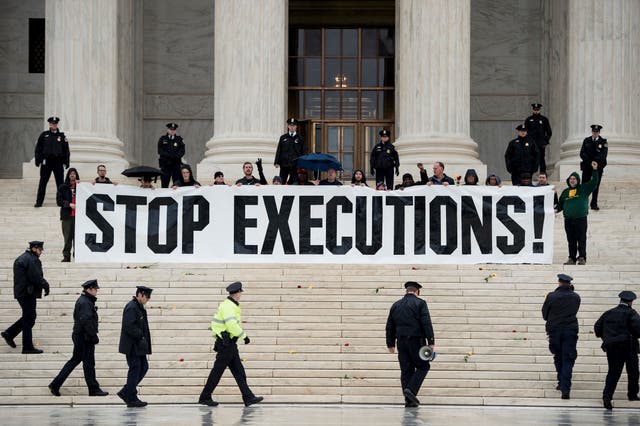 <p>Police officers gather to remove activists during an anti death penalty protest in front of the US Supreme Court 17 January 2017 in Washington, DC</p>