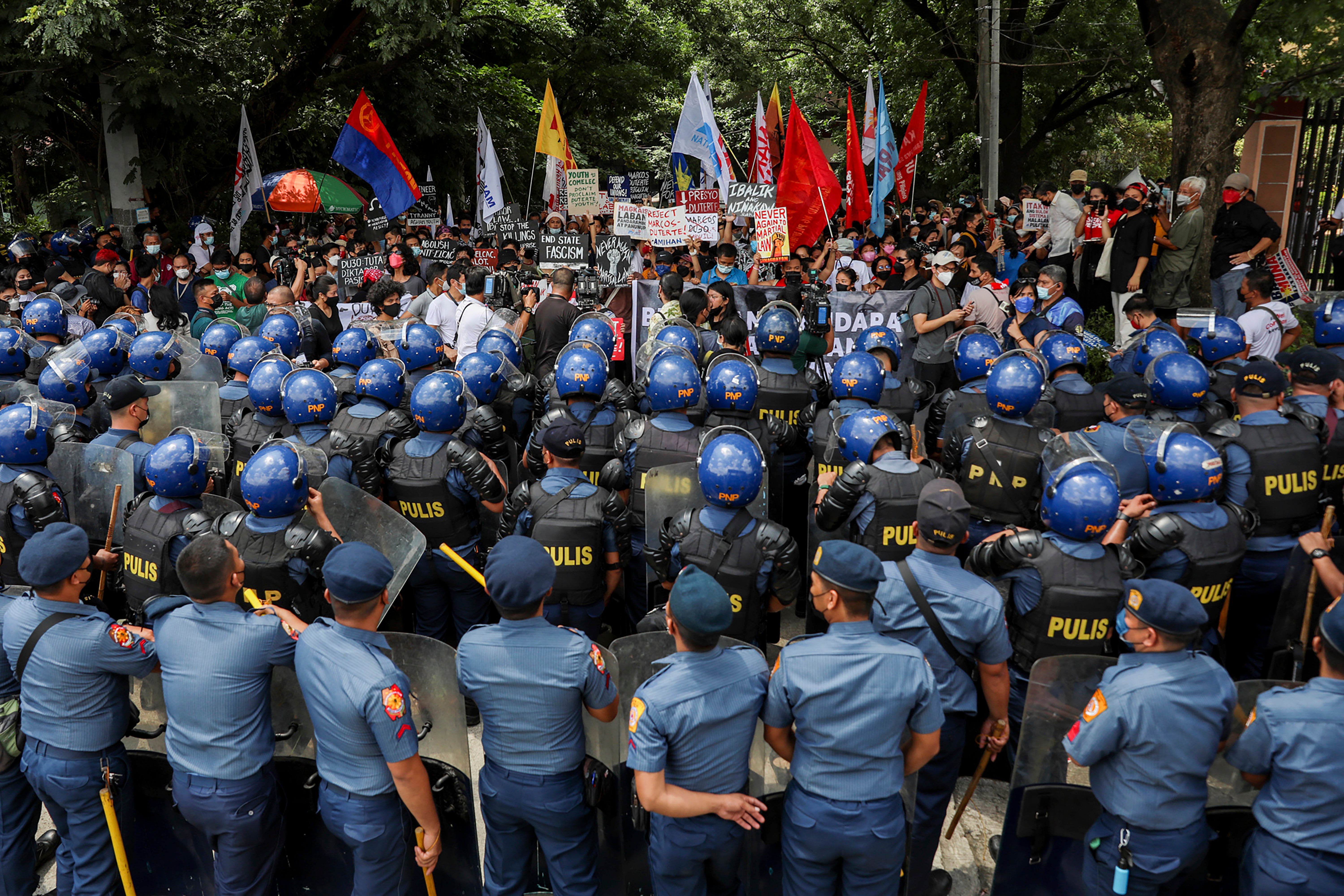 Police block activists during a rally at the Commission on Human Rights in Quezon City