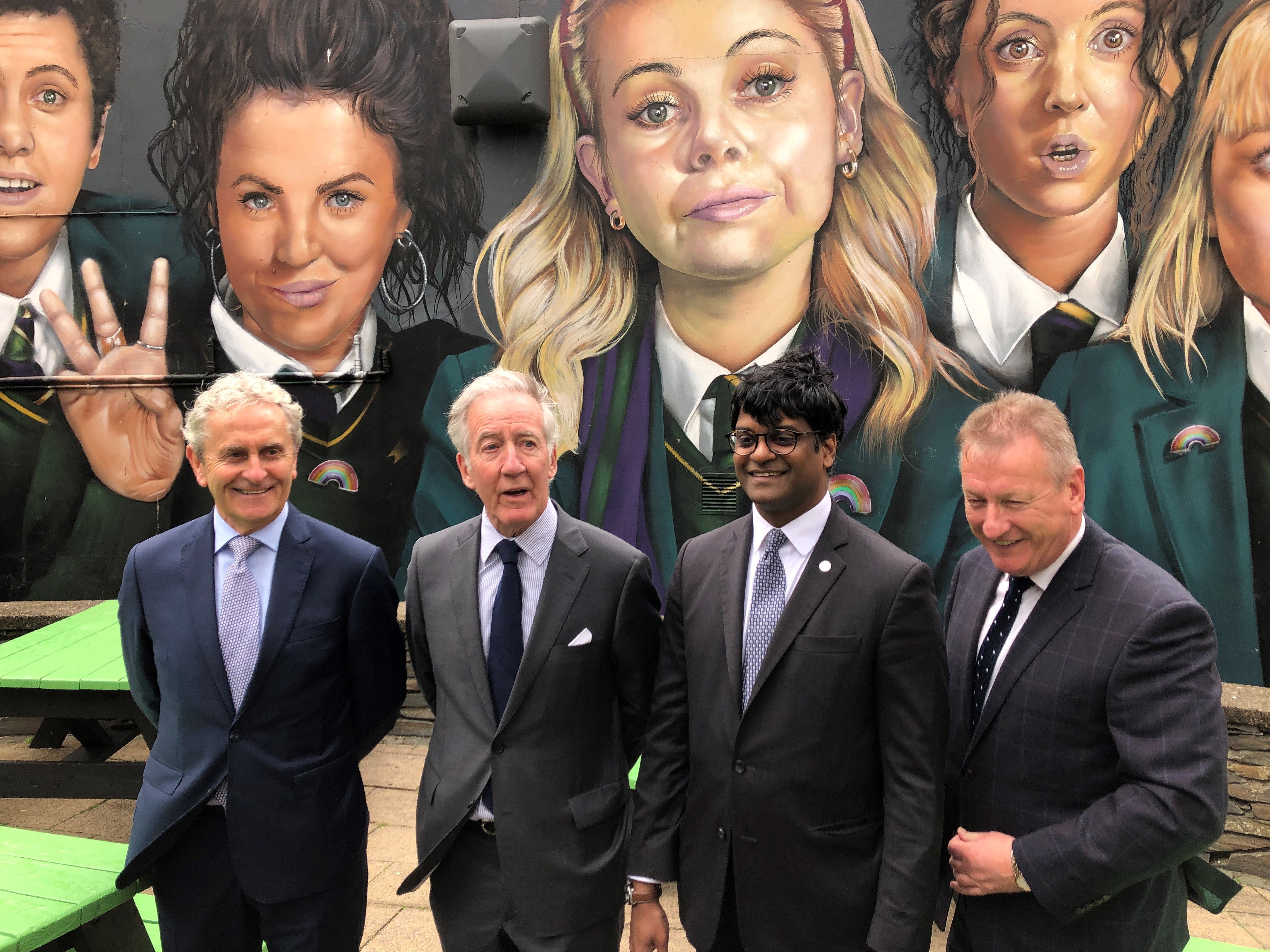 Congressman Richard Neal (second left) visits the Derry Girls mural (David Young/PA)