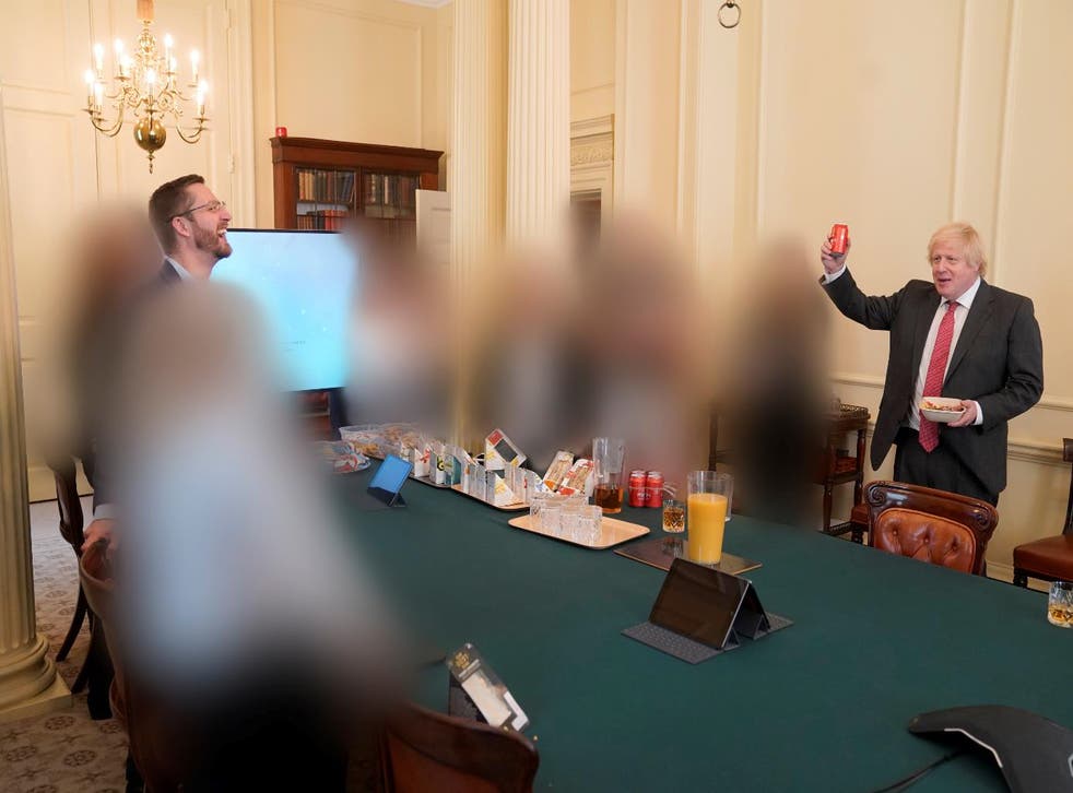 <p>Boris Johnson raises what appears to be a beer on his birthday with cabinet secretary Simon Case in attendance</p>