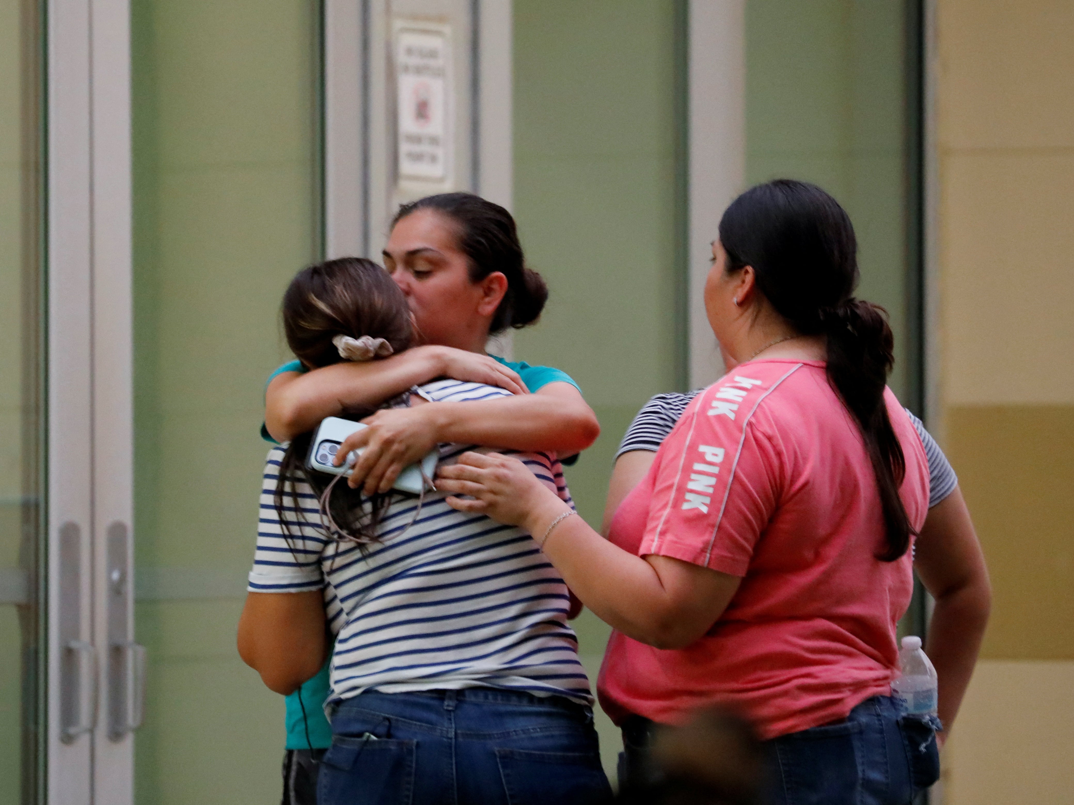 People react outside the Willie de Leon Civic Center in Uvalde, Texas