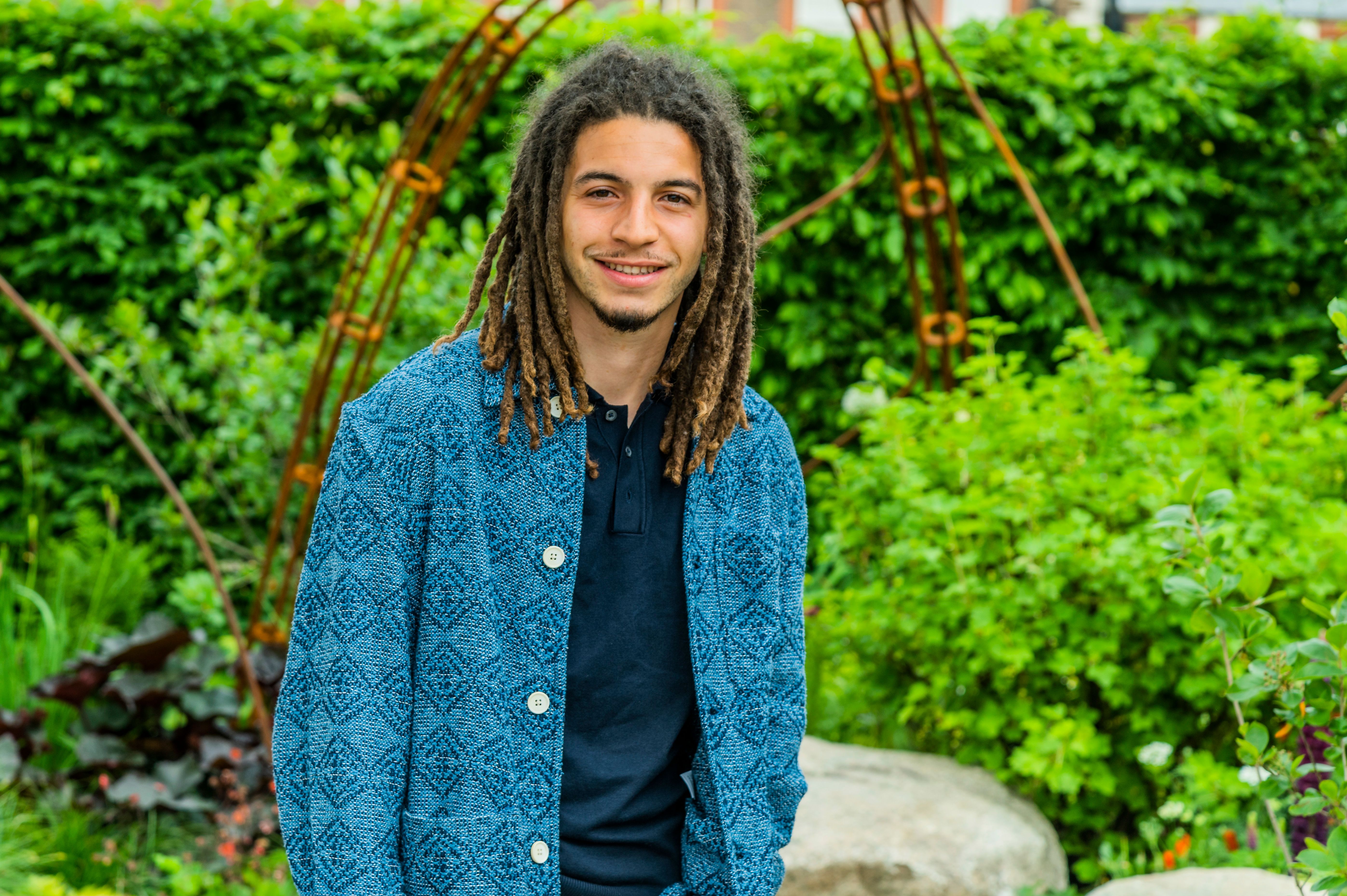 Tayshan Hayden-Smith poses in front of the “Hands Off Mangrove” garden at the Chelsea Flower Show.
