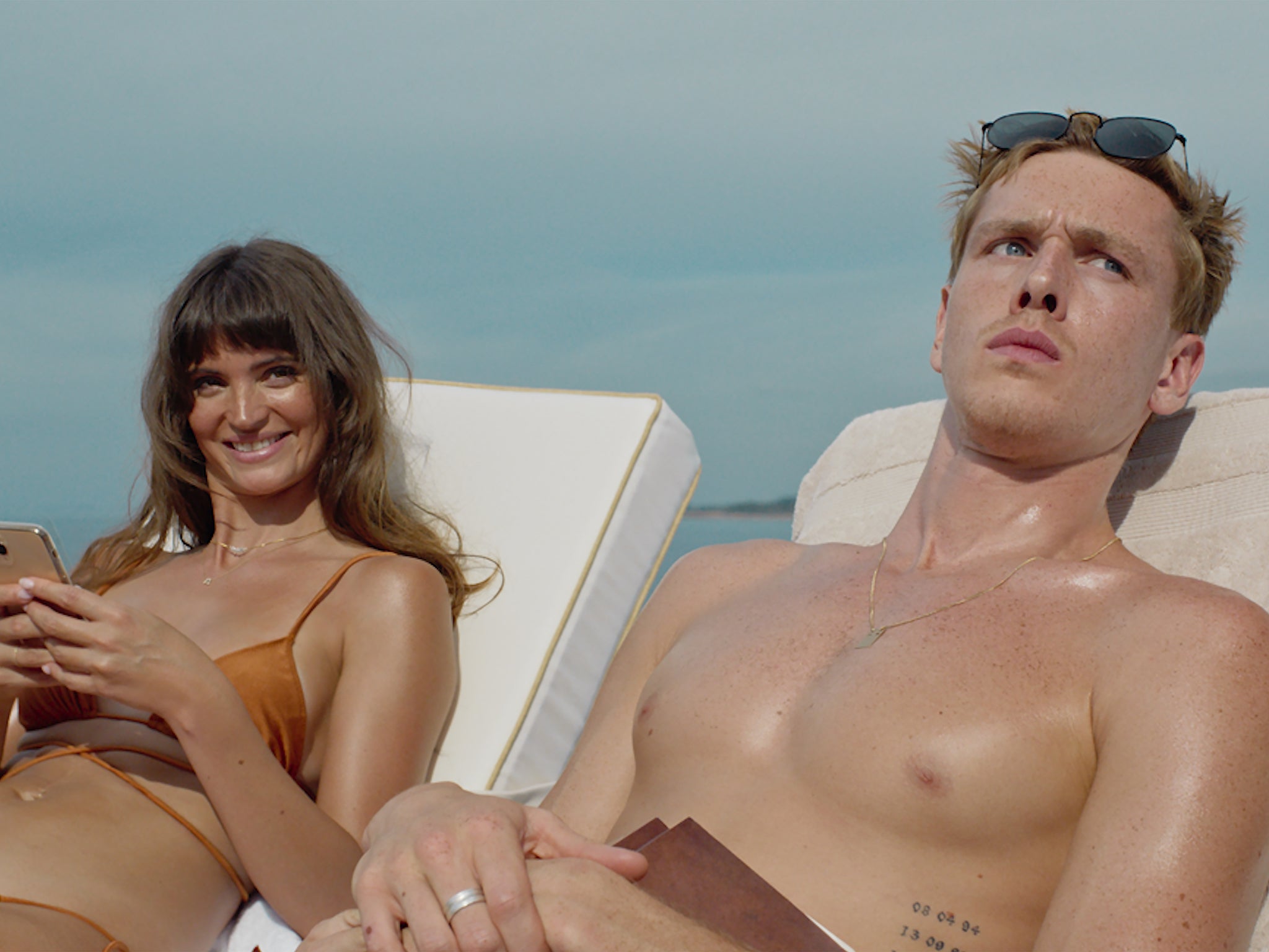 Harris Dickinson as aspiring model Carl and Charlbi Dean as Yaya, his influencer girlfriend, who end up on a luxury cruise with billionaires in Cannes hit ‘Triangle of Sadness’