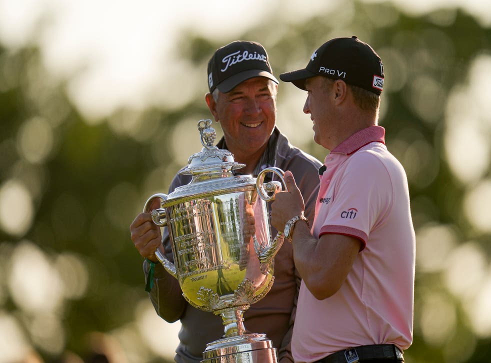 Justin Thomas poses with the Wanamaker Trophy with his father Mike after winning the US PGA Championship (Sue Ogrocki/AP)