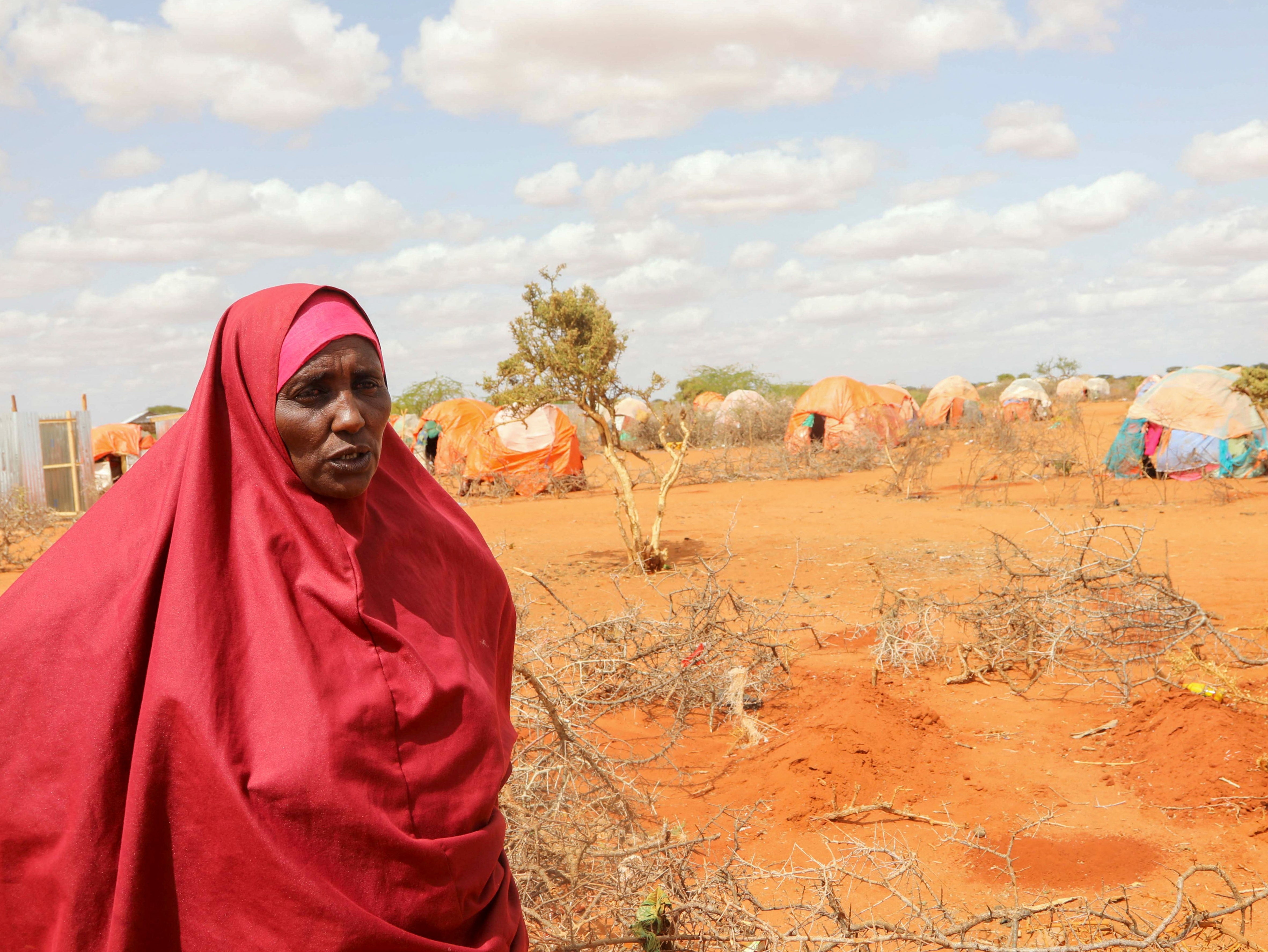 Halima Hassan Abdullahi stands near the graves of her twin granddaughters Ebla and Abdia