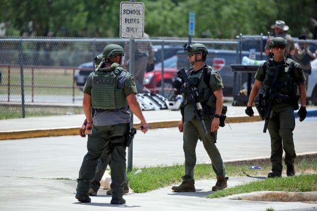 <p>Law enforcement personnel stand outside Robb Elementary School following a shooting, Tuesday, May 24, 2022, in Uvalde, Texas.</p>