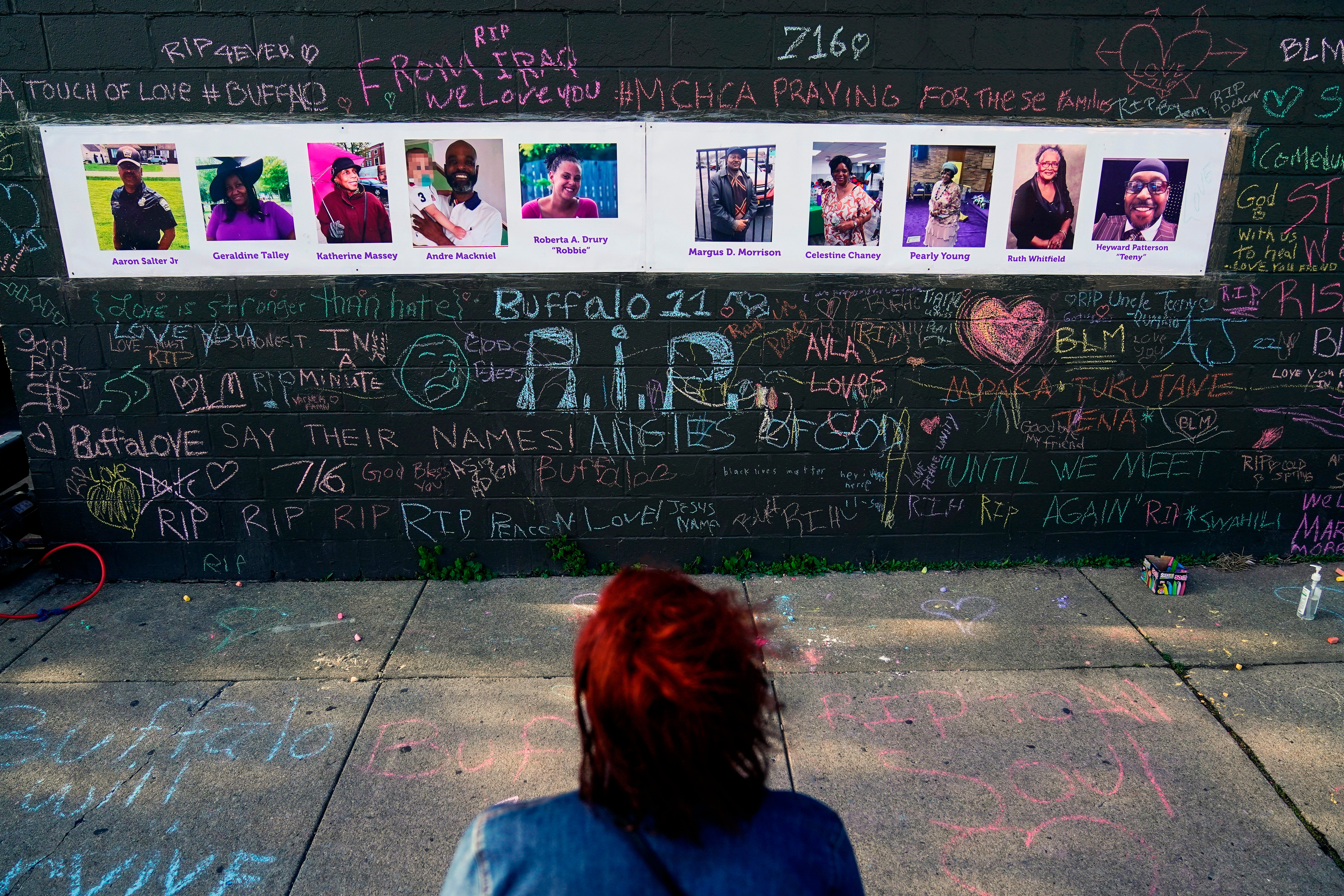 A person visits a makeshift memorial near the scene of the shooting at a supermarket in Buffalo, on May 19, 2022, six days before the second anniversary of George Floyd's killing.