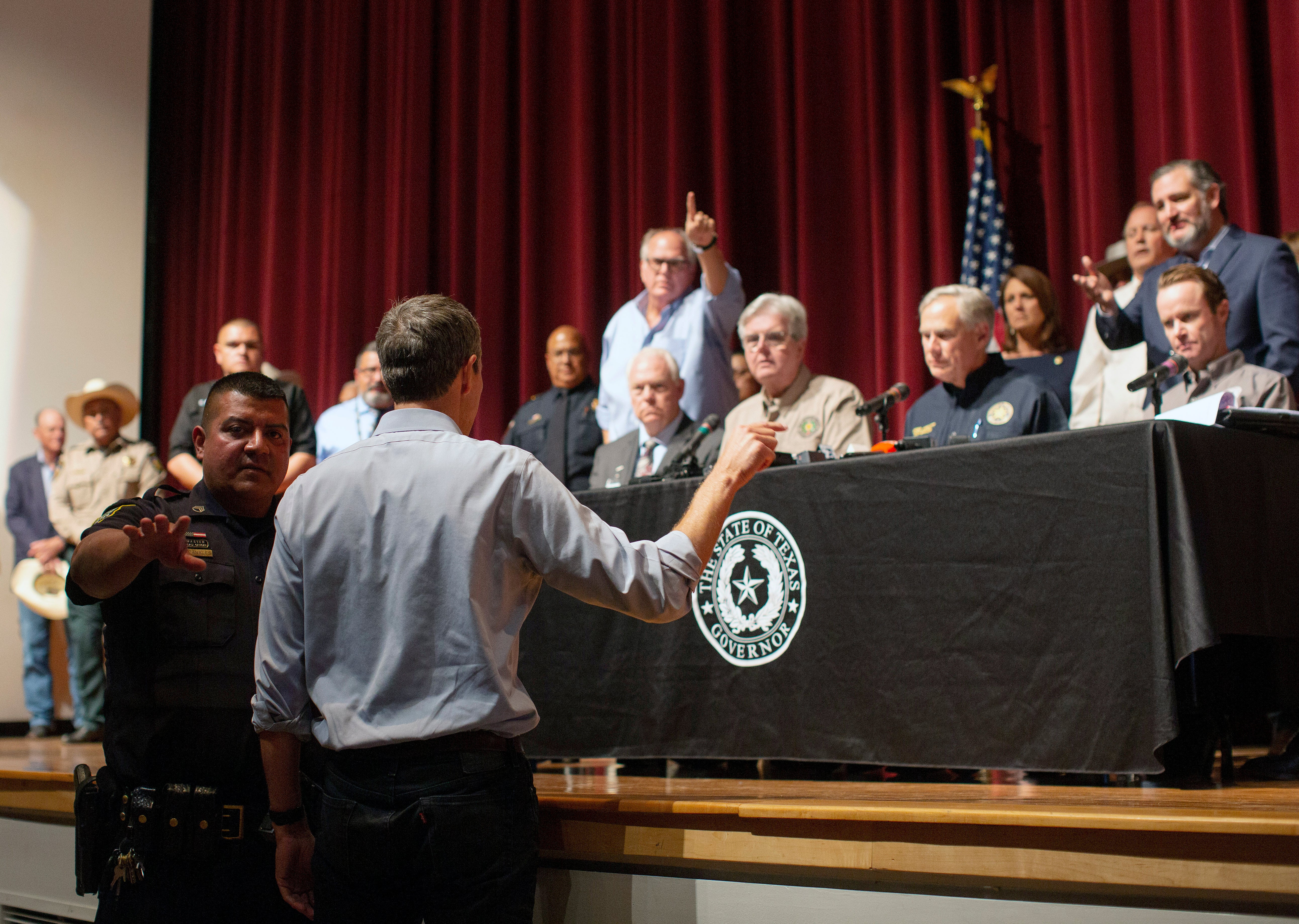 Democrat Beto O'Rourke, who is running against Greg Abbott for governor in 2022, interrupts a news conference headed by Texas Gov. Greg Abbott in Uvalde, Texas Wednesday, May 25, 2022. (AP Photo/Dario Lopez-Mills)