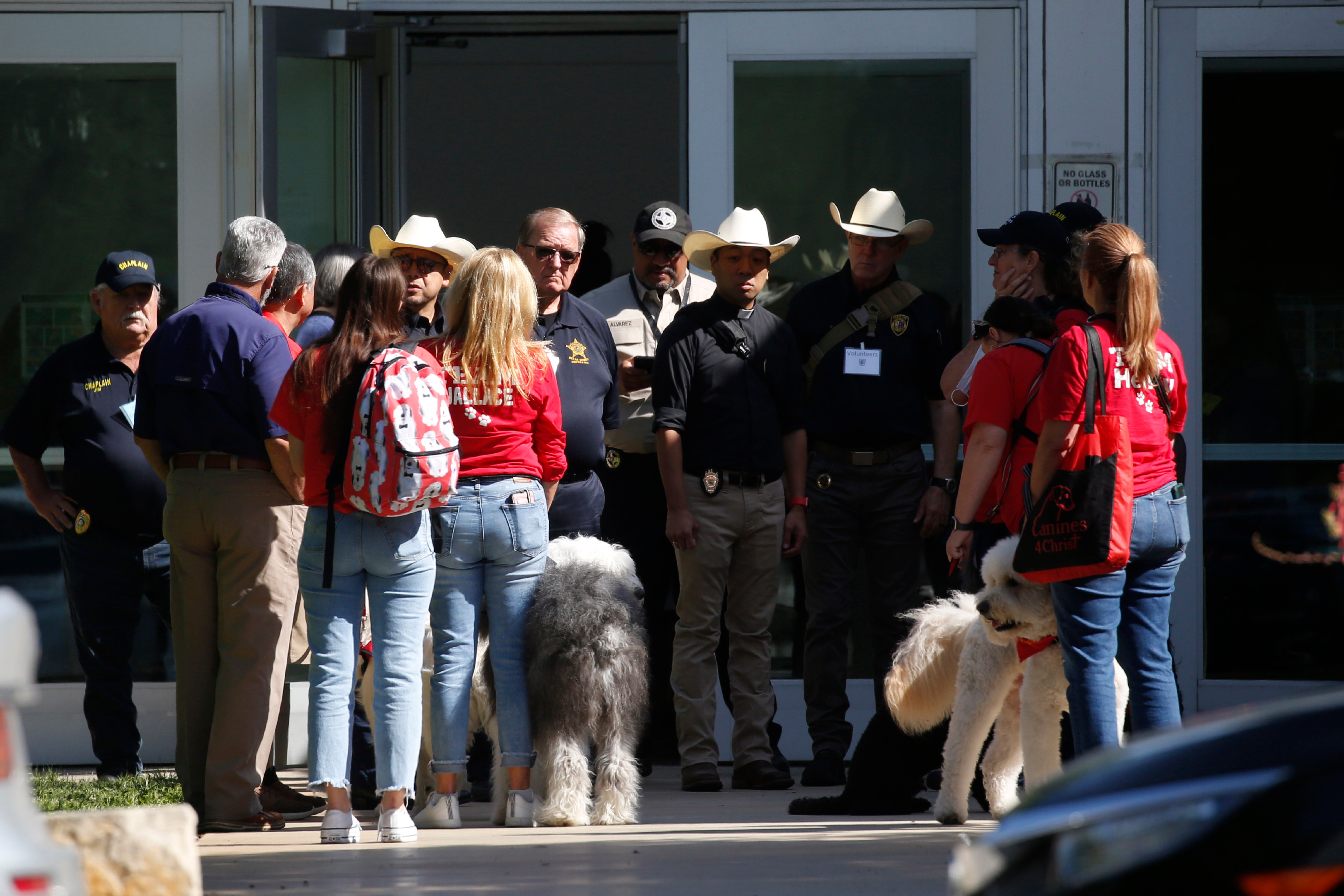 Police and members of the Brooke Army Medical Center Therapy Dogs unit gather outside of the Civic Center in Uvalde, Texas, Wednesday, May 25, 2022. The 18-year-old gunman who slaughtered 19 children and two teachers at a Texas elementary school barricaded himself inside a single classroom and “began shooting anyone that was in his way,” authorities said Wednesday in detailing the latest mass killing to rock the U.S. (AP Photo/Dario Lopez-Mills)