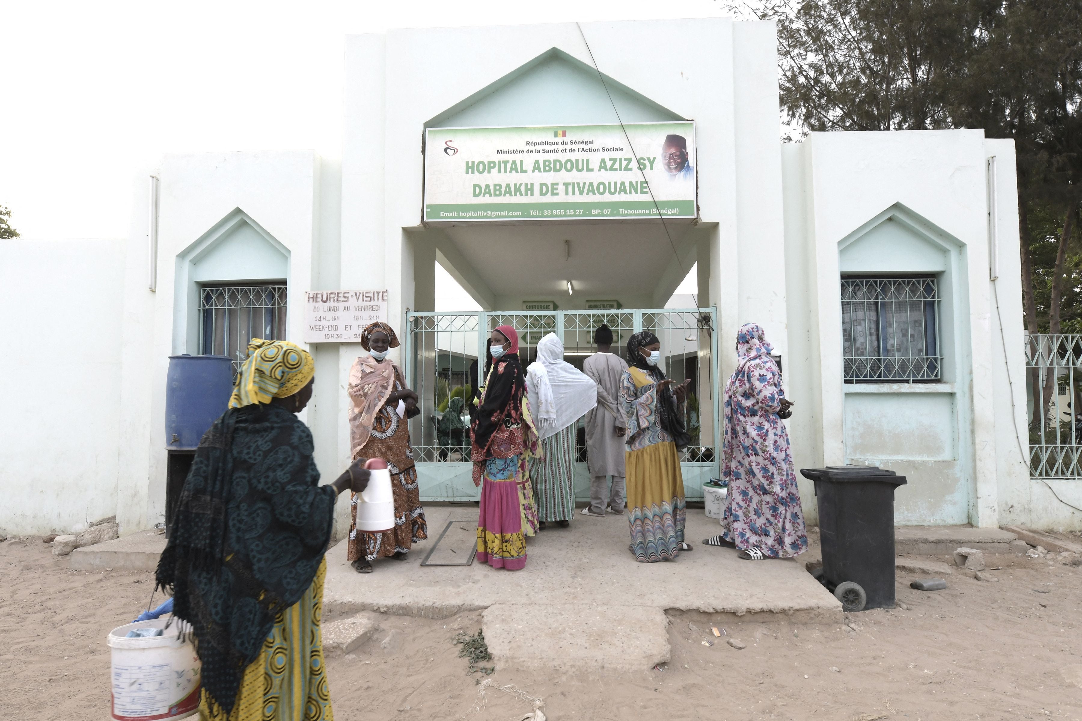 Visitors stand in front of the Mame Abdoul Aziz Sy Dabakh hospital in Tivaouane city, where 11 babies died following an electrical fault