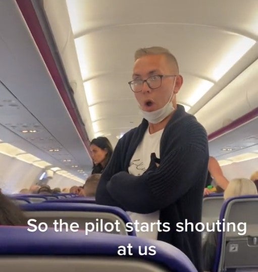 <p>Passengers on the grounded Wizz Air flight react to the angry pilot</p>