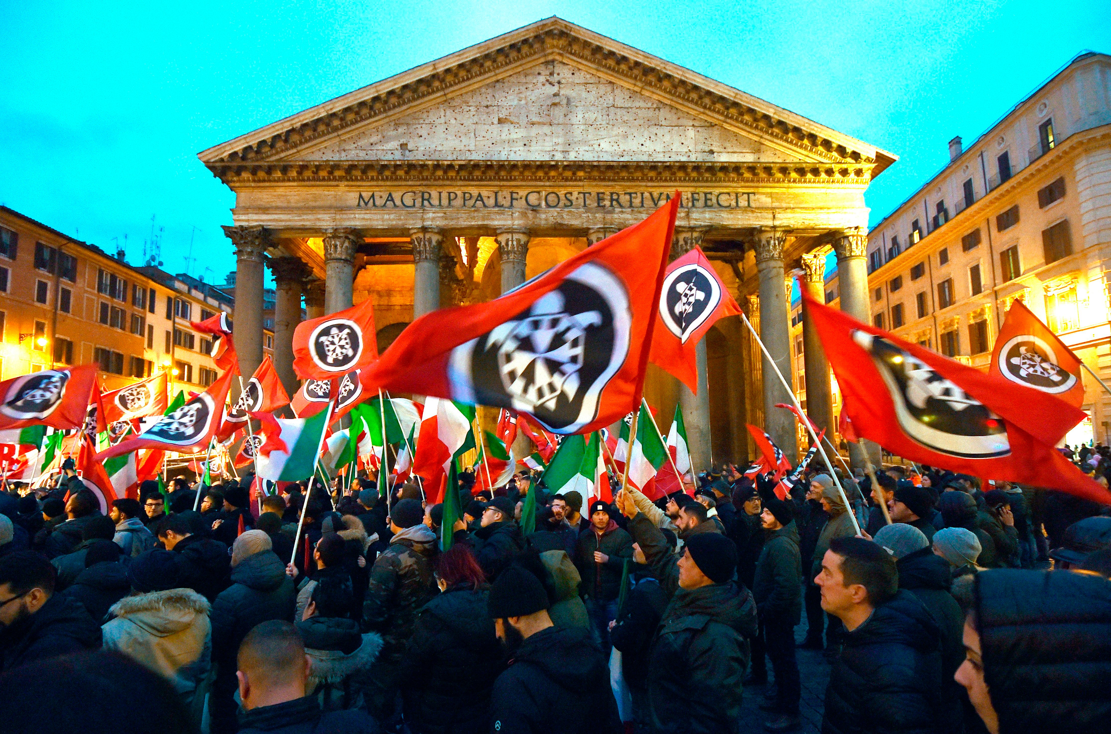 CasaPound activists wave flags during an election campaign rally in front of the Pantheon in Rome, 2018