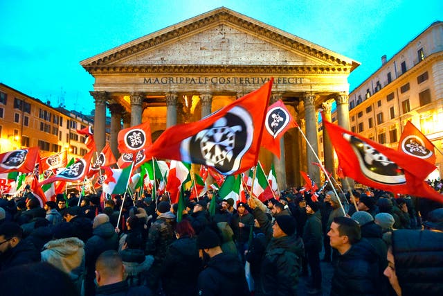 <p>CasaPound activists wave flags during an election campaign rally in front of the Pantheon in Rome, 2018</p>