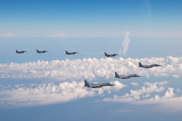 <p>Three F-15 warplanes of the Japanese Self-Defense Force, front, and four F-16 fighters of the US Armed Forces fly over the Sea of Japan on Wednesday</p>