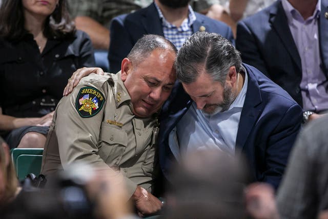 <p>Uvalde County Sheriff Ruben Nolasco, left, is comforted by US Senator Ted Cruz during a vigil held in honor of the lives lost at Robb Elementary school at the Uvalde County Fairplex Arena in Uvalde, Texas, Wednesday, May 25, 2022. (Josie Norris/The San Antonio Express-News via AP)</p>
