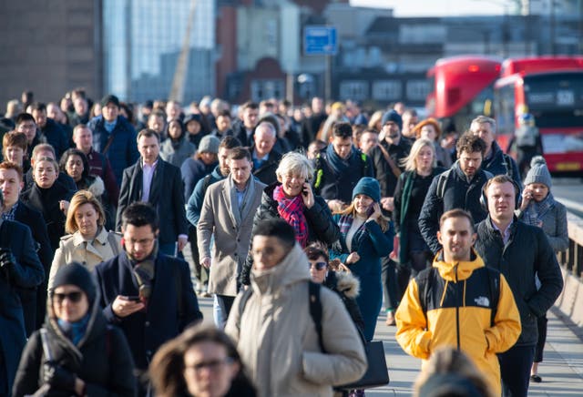 Commuters crossing London Bridge, in central London (Dominic Lipinski/PA)