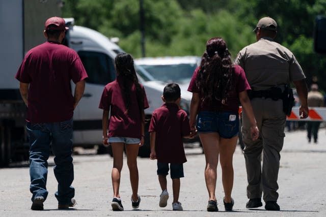 <p>A family is escorted onto the campus of Robb Elementary School in Uvalde, Texas after a gunman killed 19 students and two adults in a massacre earlier this week</p>