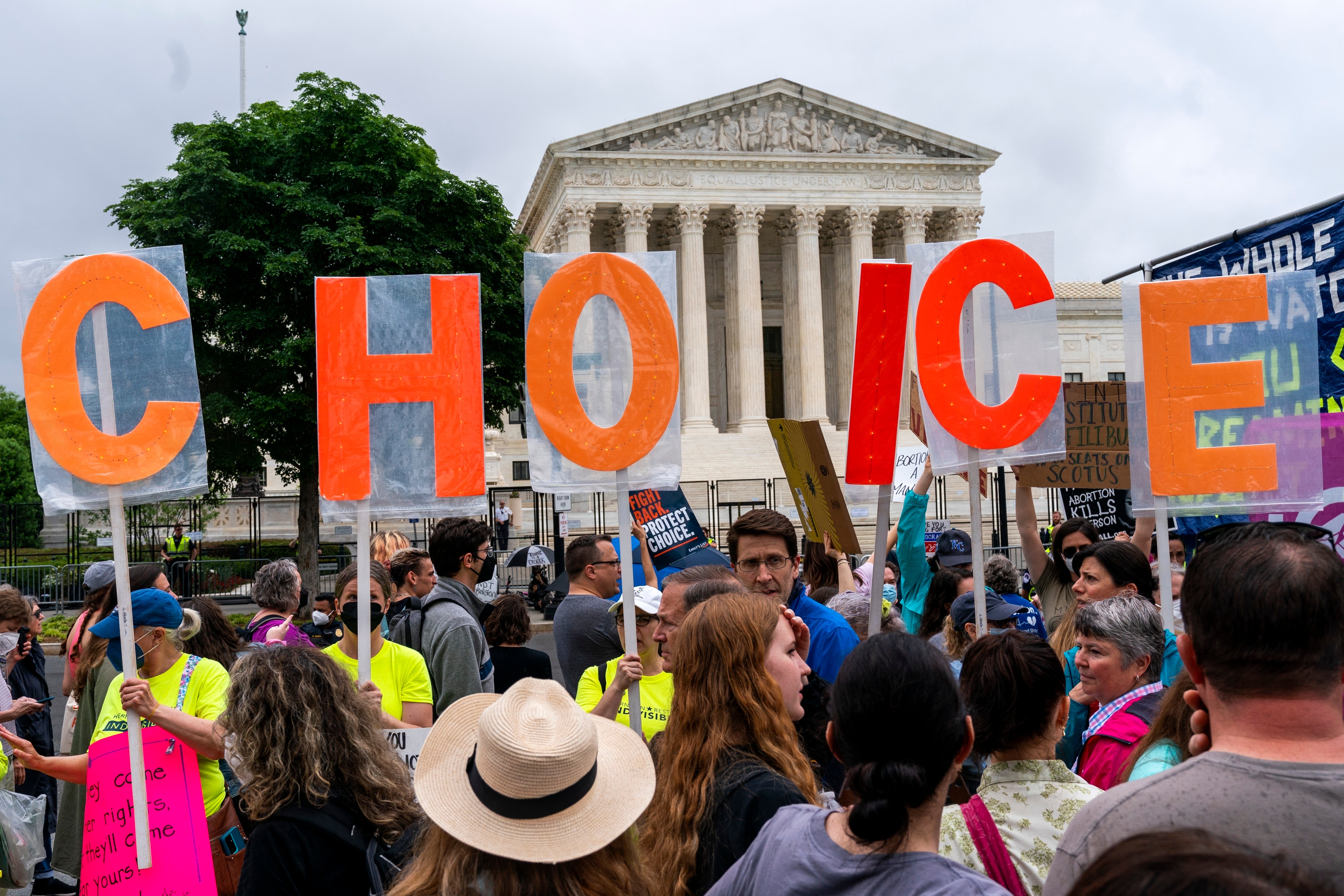Abortion-rights demonstrators hold up letters spelling out "My Choice," Saturday, May 14, 2022, outside the Supreme Court in Washington. (AP Photo/Jacquelyn Martin)