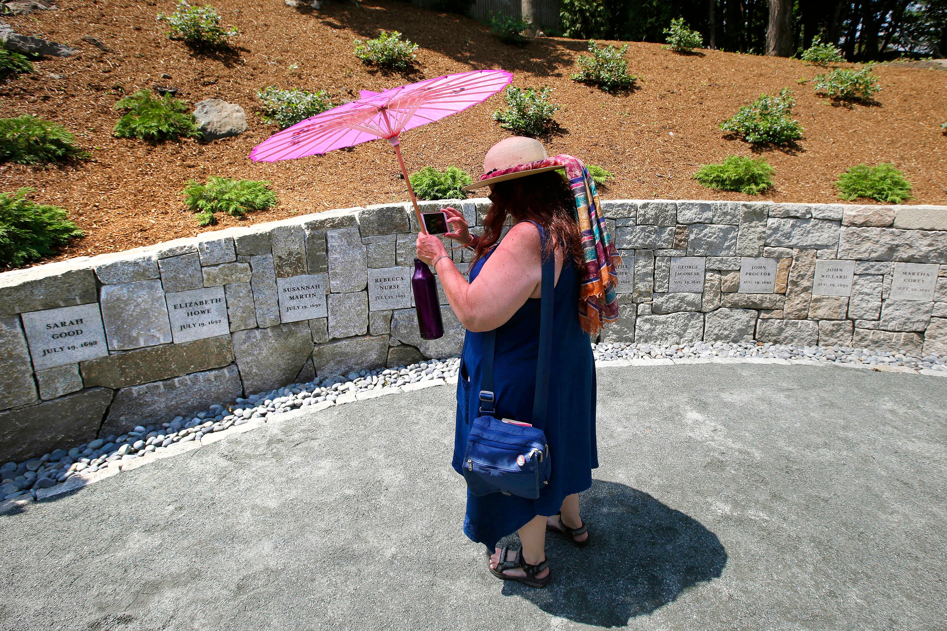 Karla Hailer, a fifth-grade teacher from Scituate, Massachusetts, stands at the site where five women were hanged as witches more than three centuries years earlier in Salem