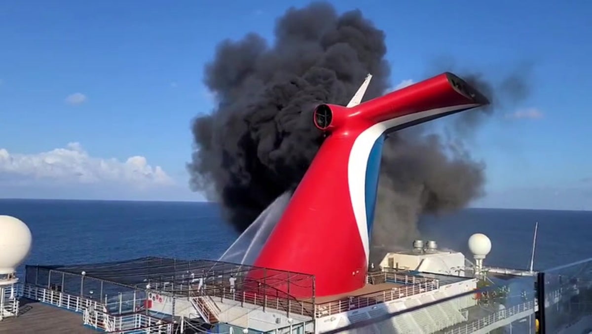 Carnival cruise ship funnel engulfed in black smoke while docked in Grand Turk