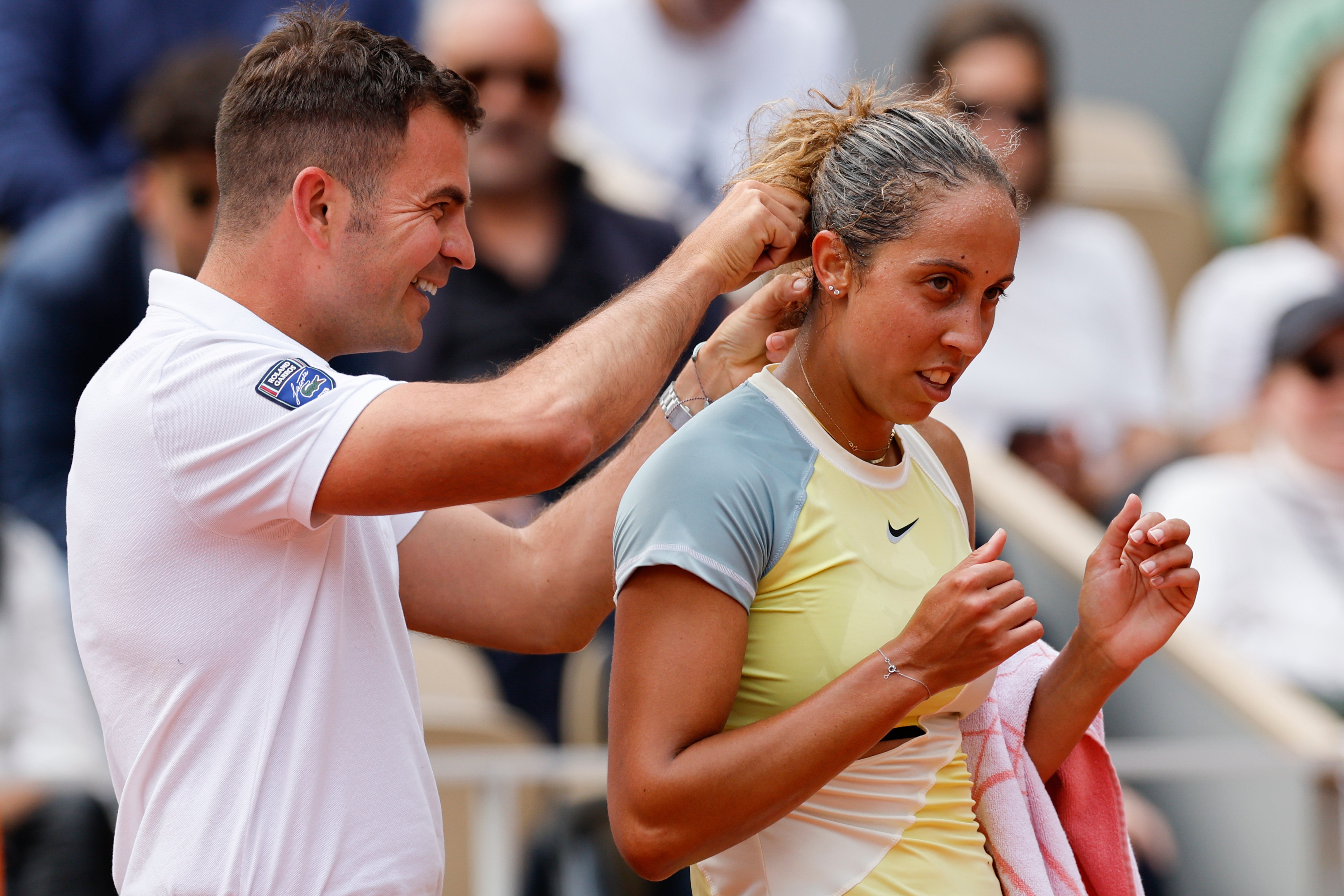 Chair umpire Jaume Campistol helps Madison Keys untangle her necklace (Jean-Francois Badias/AP)