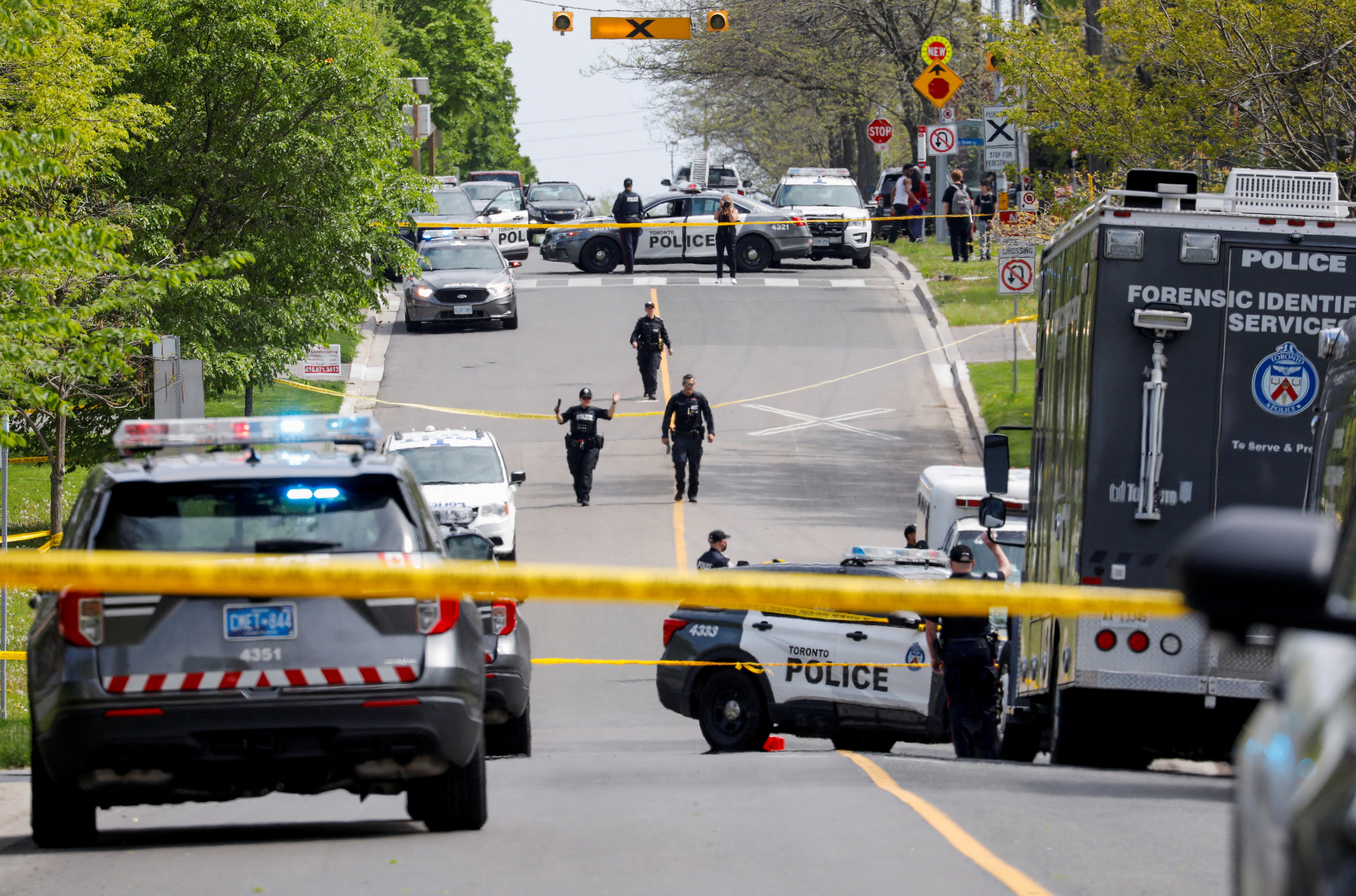 <p>Toronto officers work at the scene where police shot and injured a suspect who was walking down a city street carrying a gun </p>
